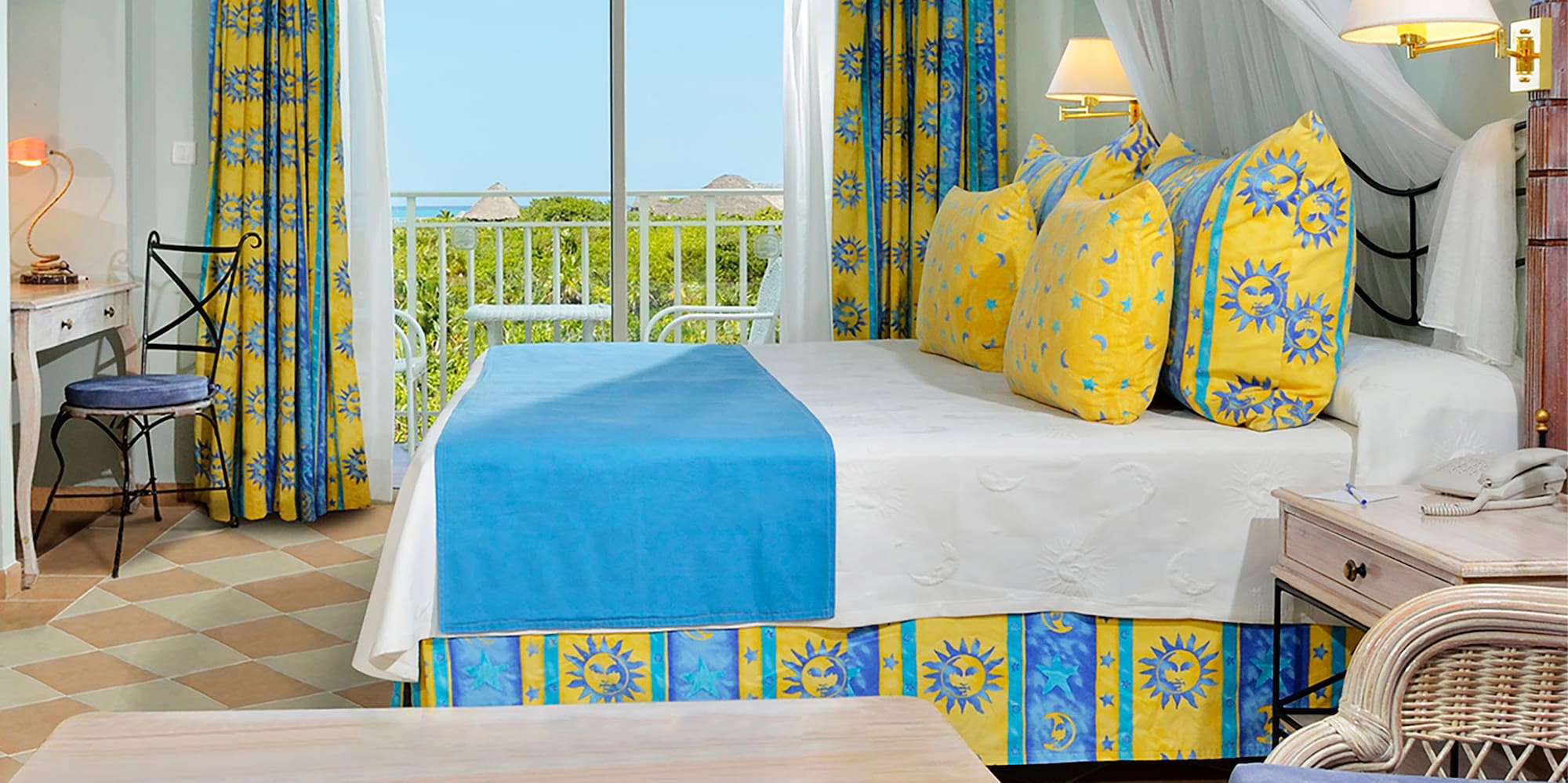 a room with a bed and chairs