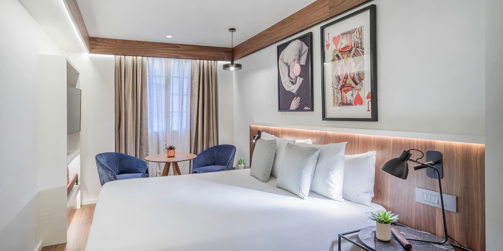 a bed with a table and chairs in a room