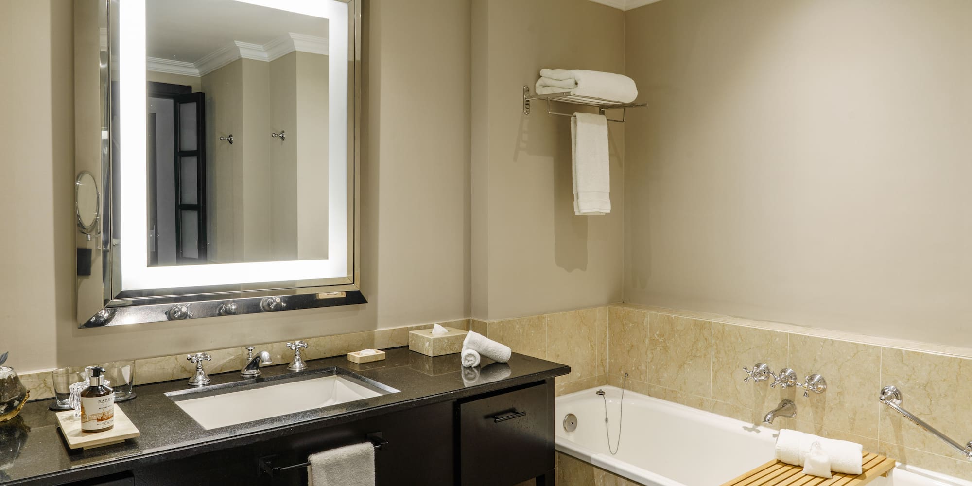 a bathroom with a bathtub and a mirror