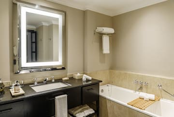 a bathroom with a bathtub and a mirror