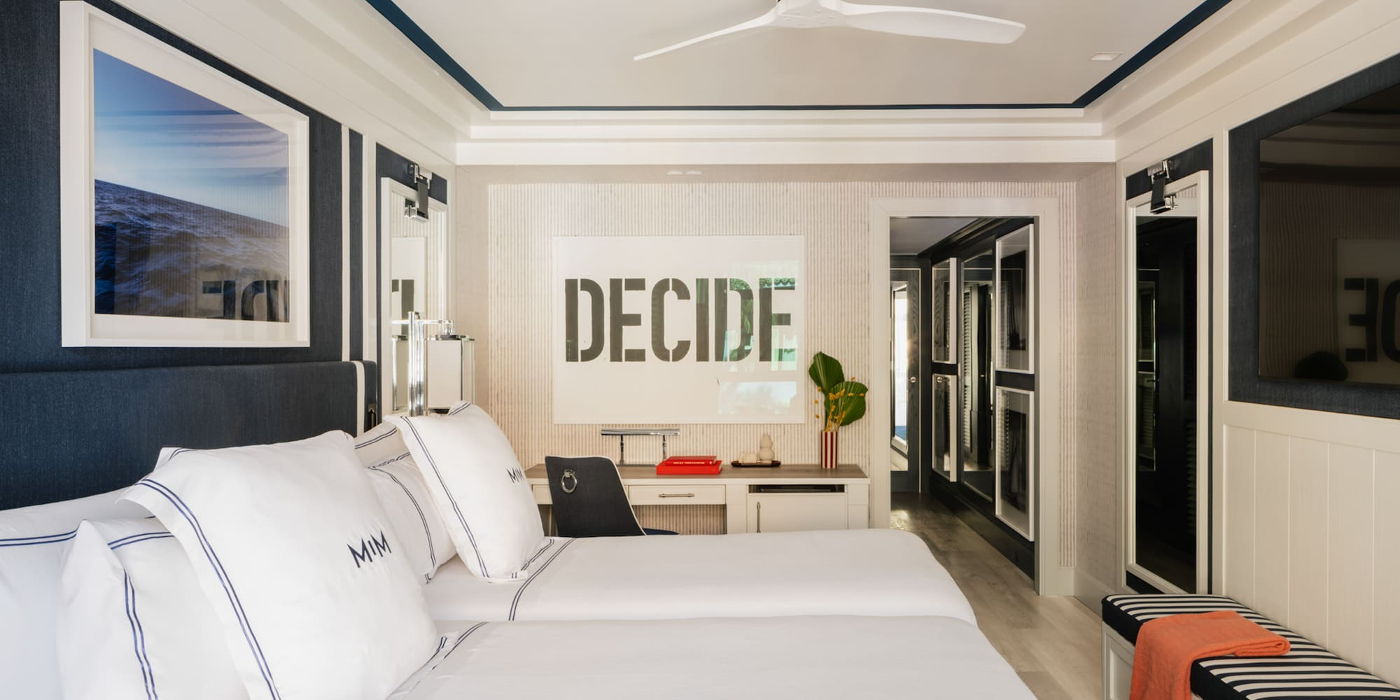 a room with two beds and a ceiling fan