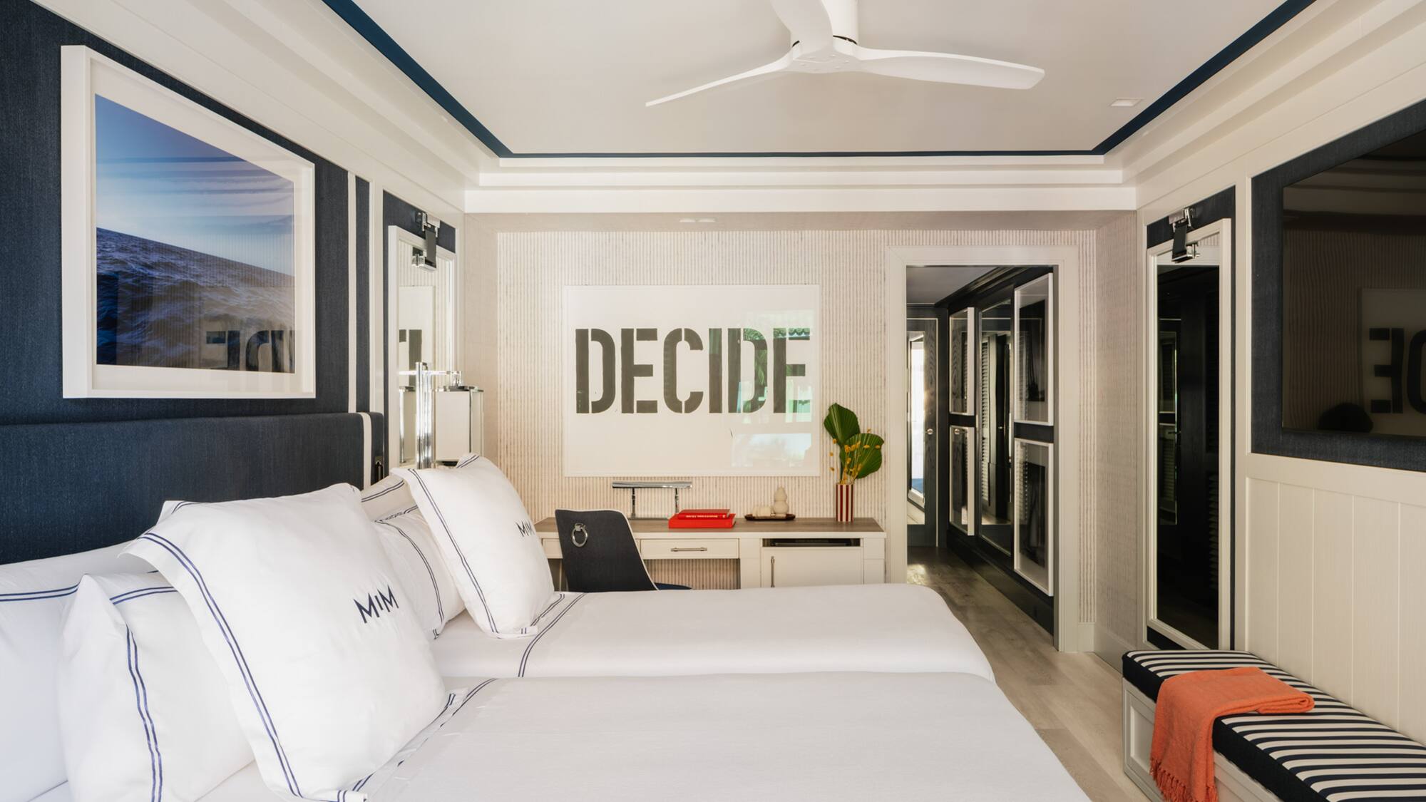a room with two beds and a ceiling fan