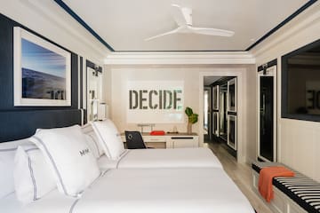a room with two beds and a ceiling fan