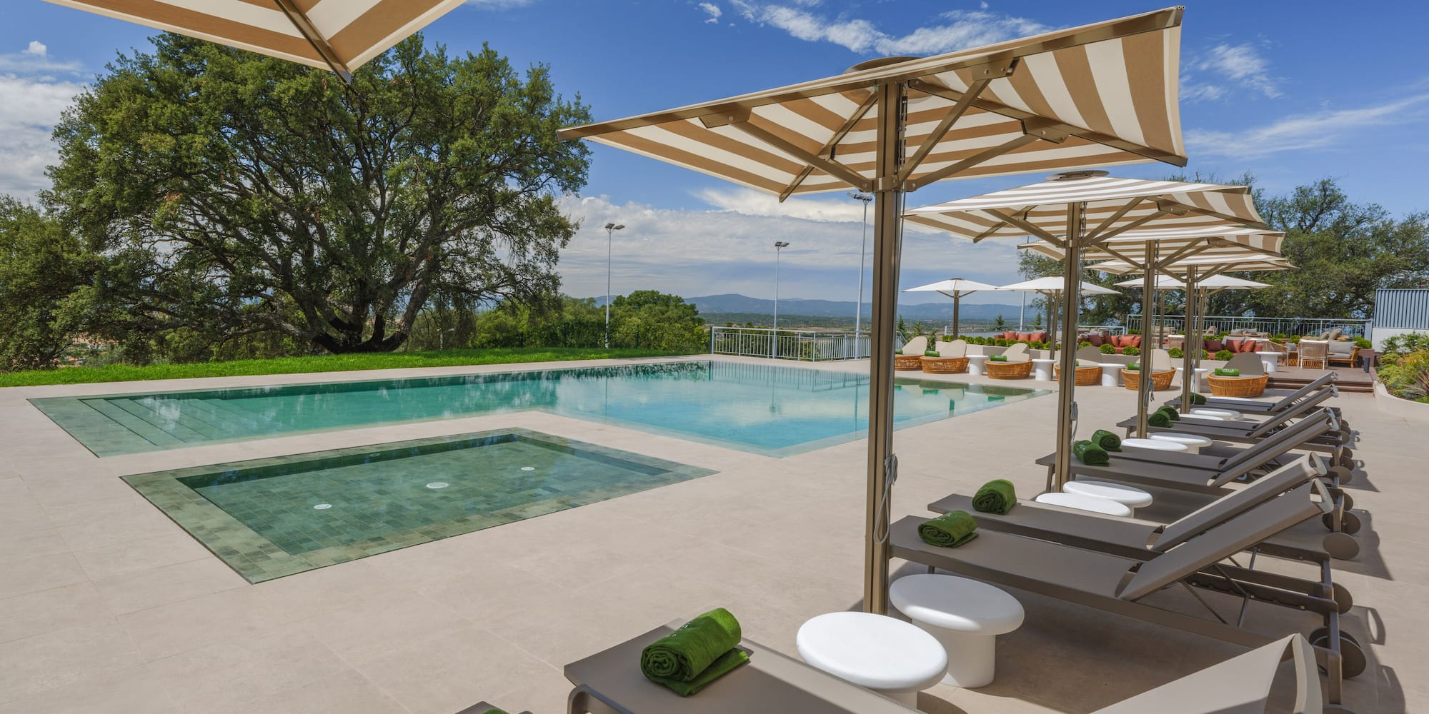 a pool with lounge chairs and umbrellas