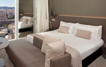 a bed with a mirror in the background