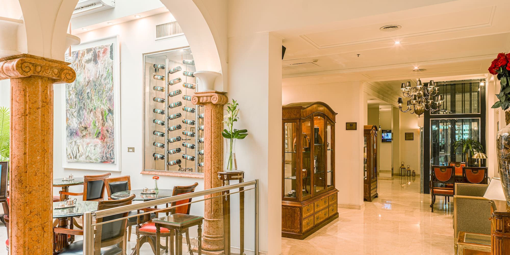 a room with a glass display case and tables