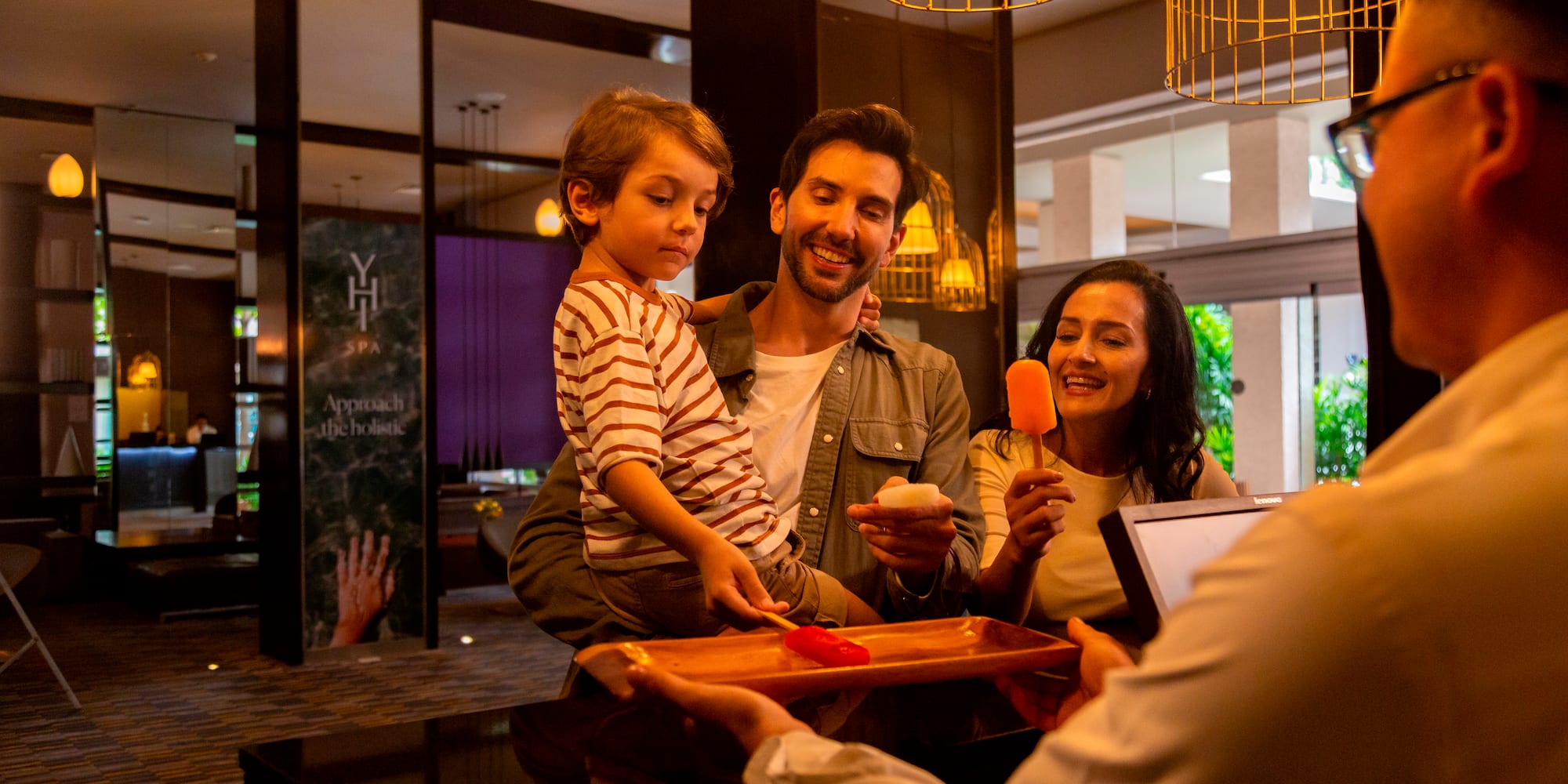 a man giving a tray of food to a family