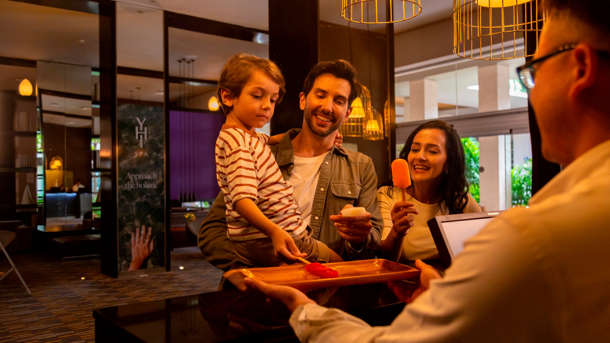 a man giving a tray of food to a family