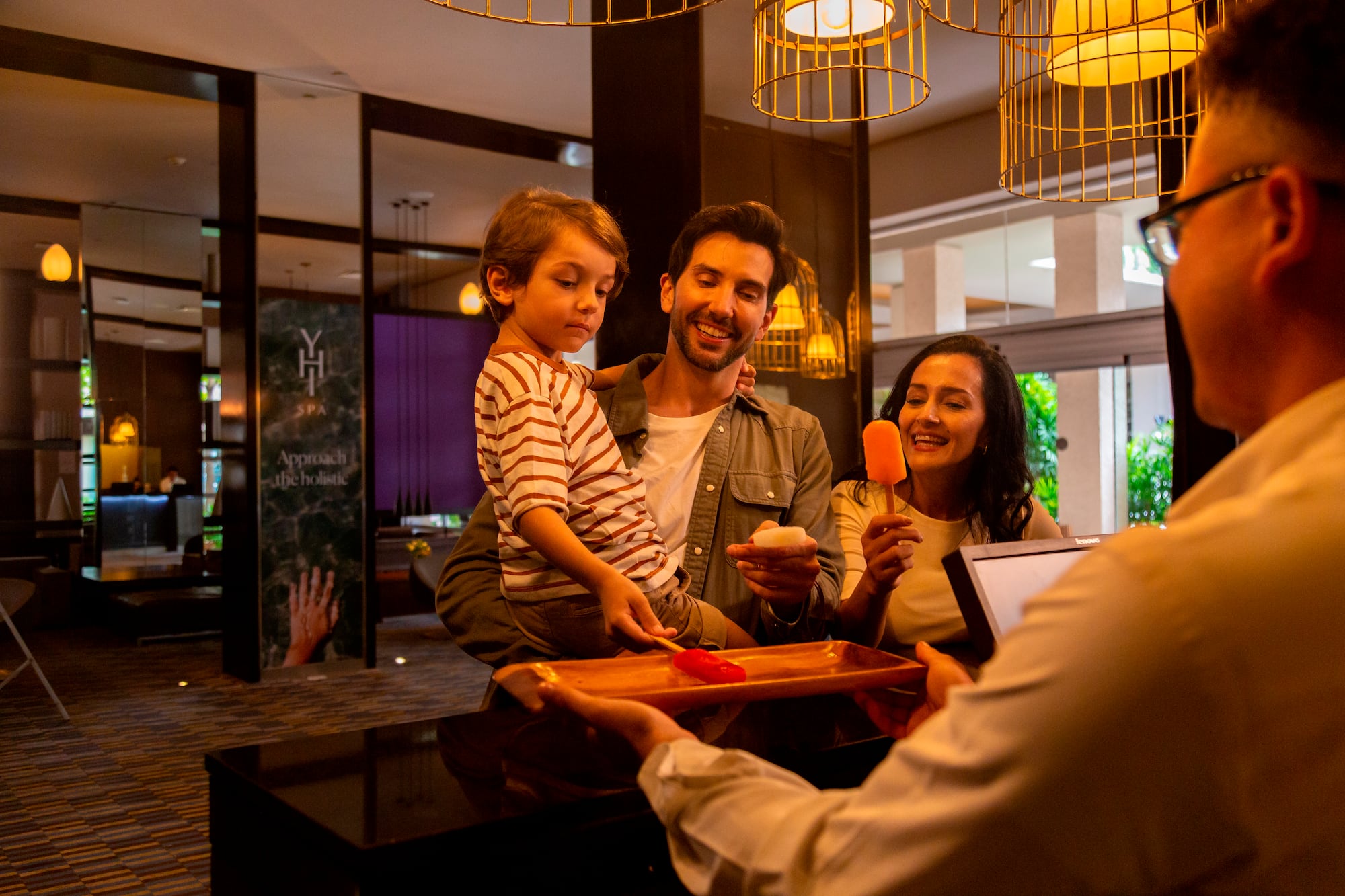 a man giving a tray of food to a family