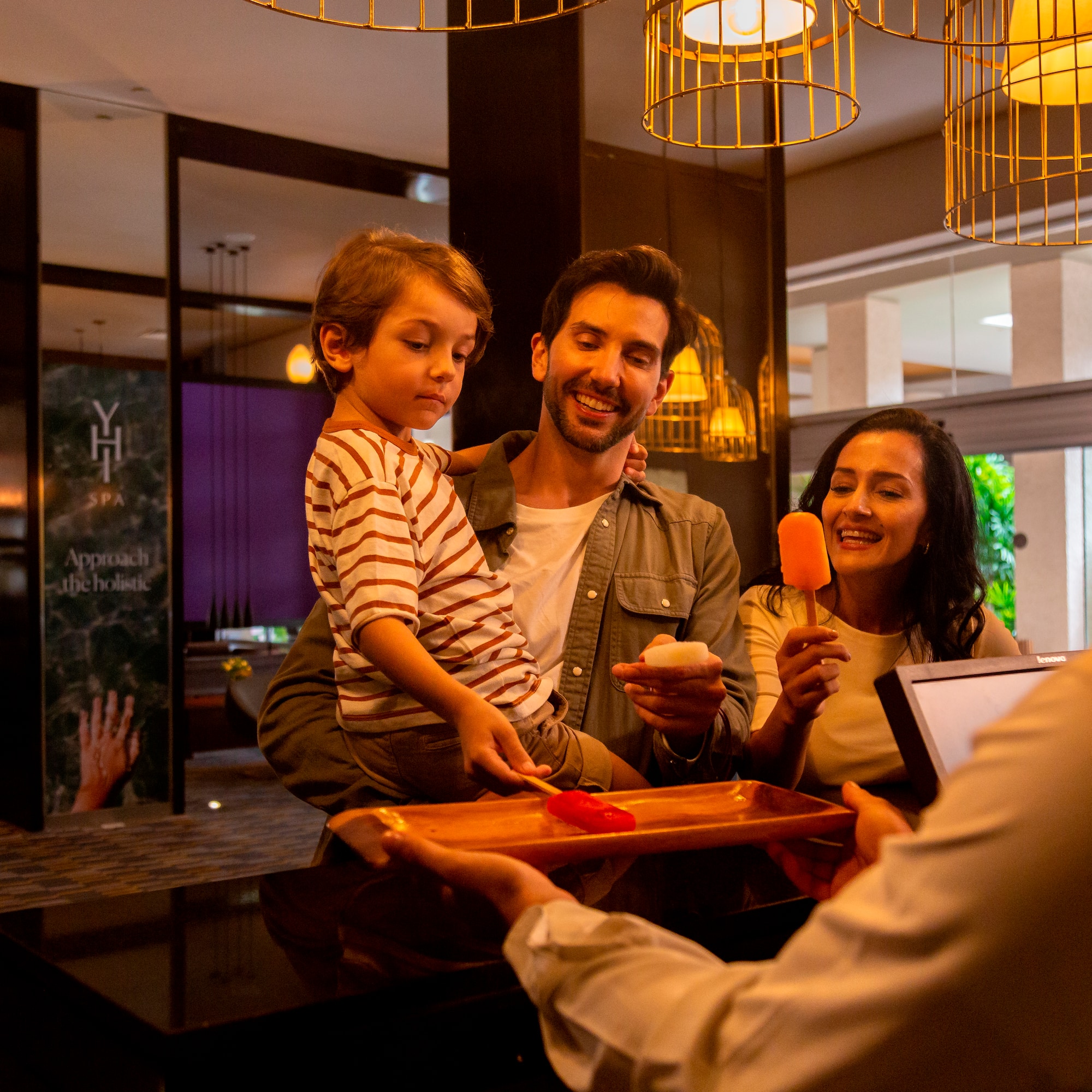 a man giving a tray of food to a family