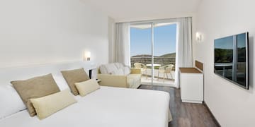 a bedroom with a bed and a sliding glass door