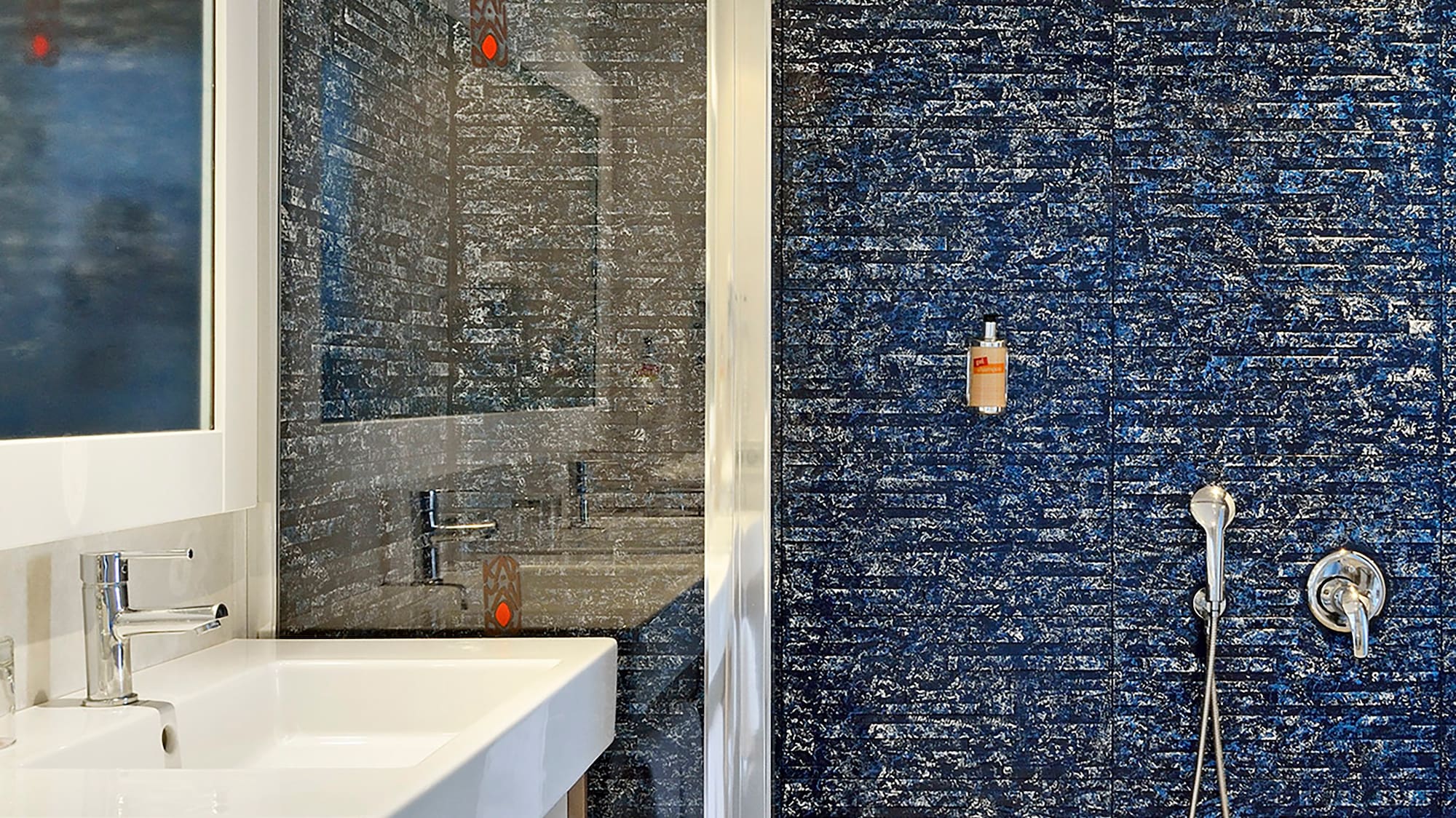 a bathroom with a shower and sink