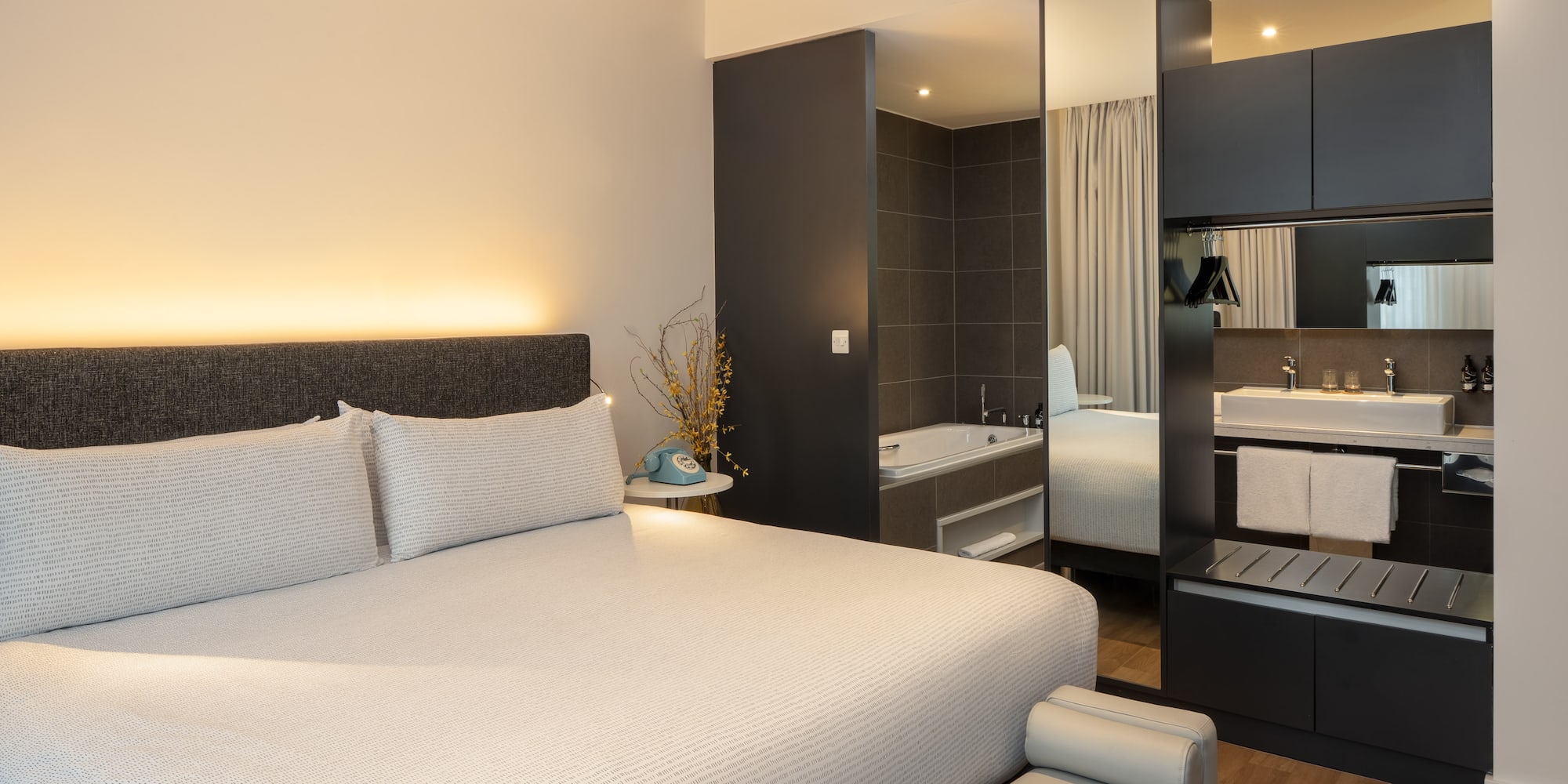 a bed with a mirror and a bathtub