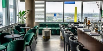 a room with green chairs and tables