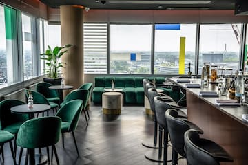 a room with green chairs and tables