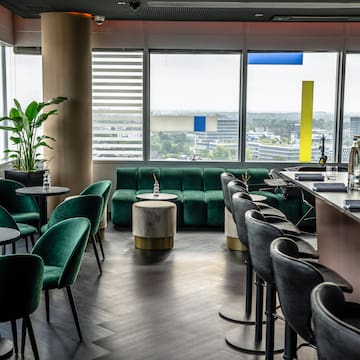 a room with green chairs and tables