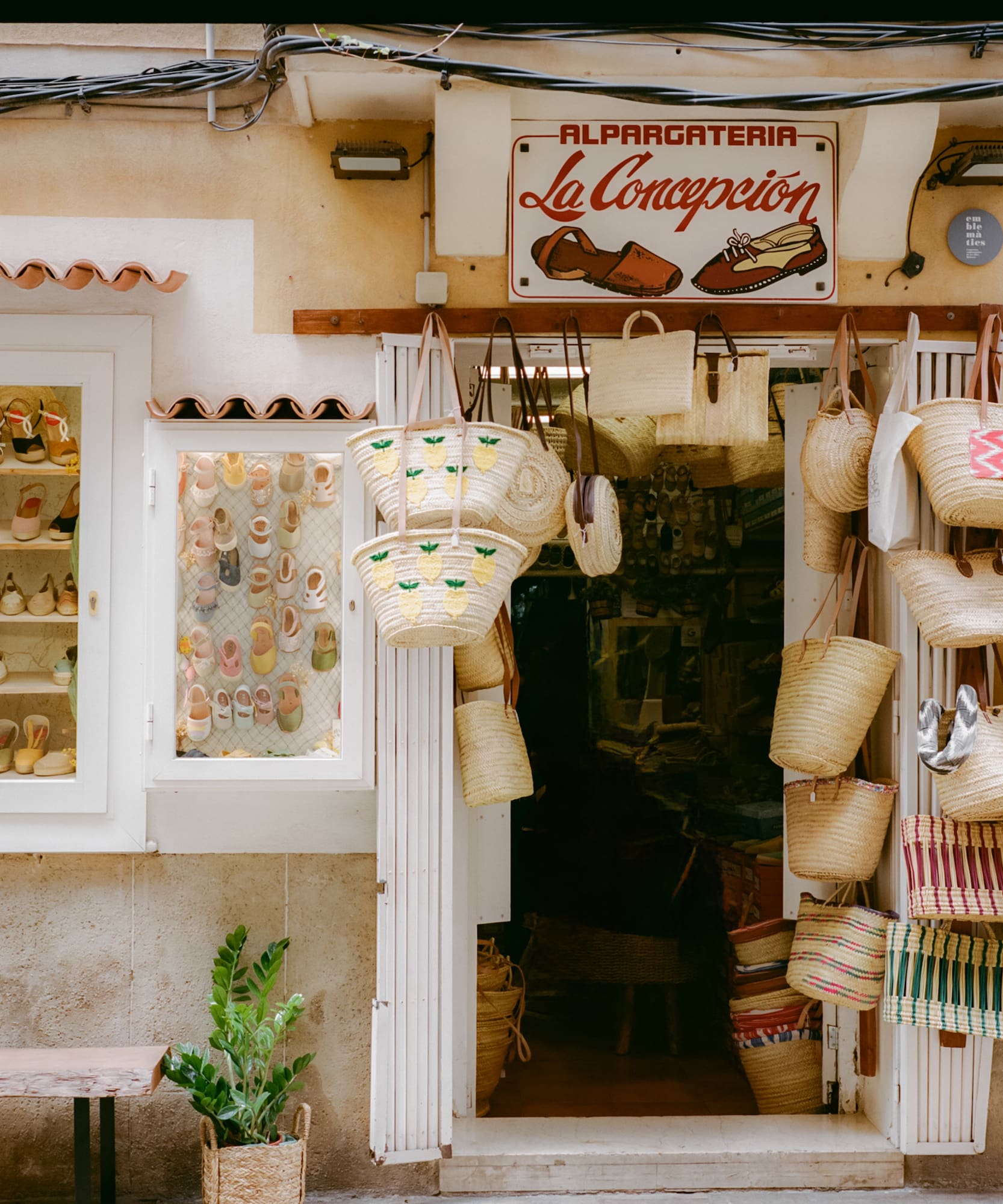 La Concepcion alpargateria facade, displaying espadrilles and woven straw bags.