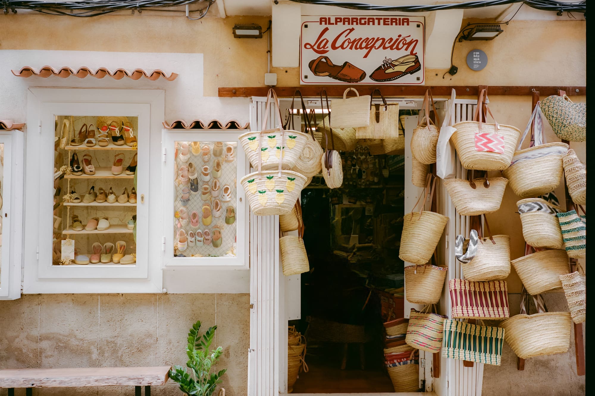 La Concepcion alpargateria facade, displaying espadrilles and woven straw bags.