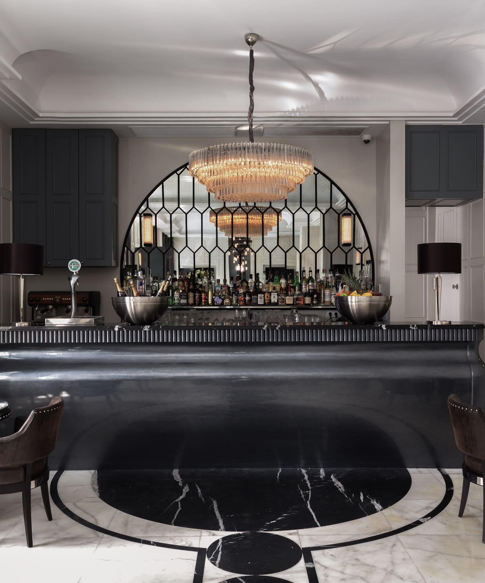 a bar with a chandelier and chairs