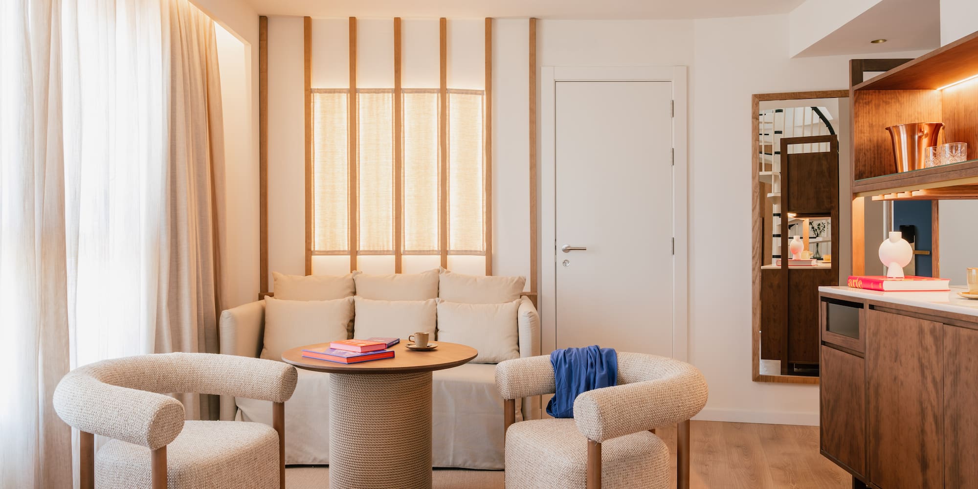 a room with a couch and chairs