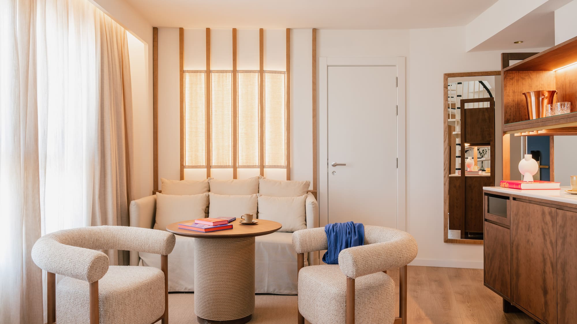 a room with a couch and chairs