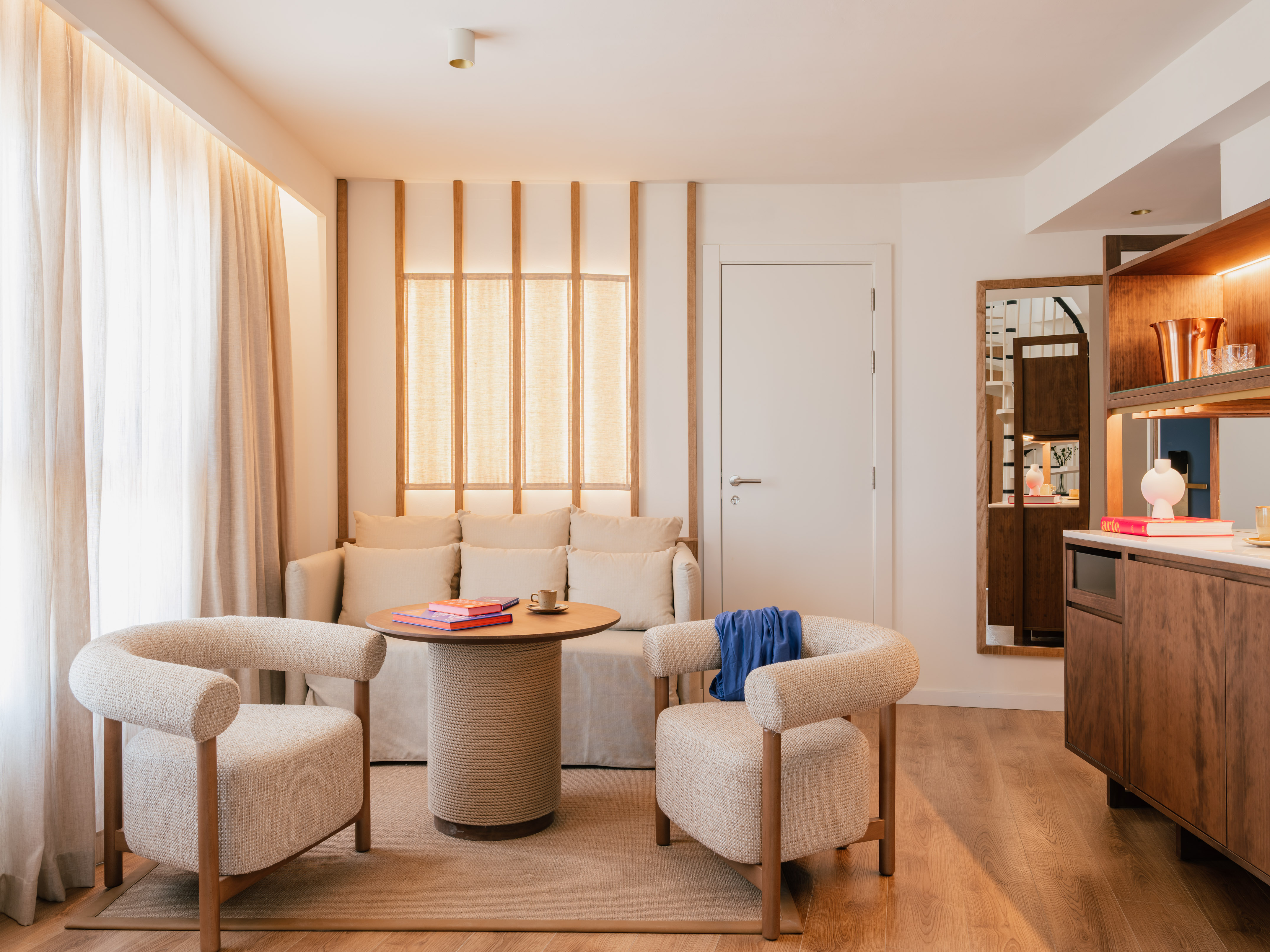 a room with a couch and chairs