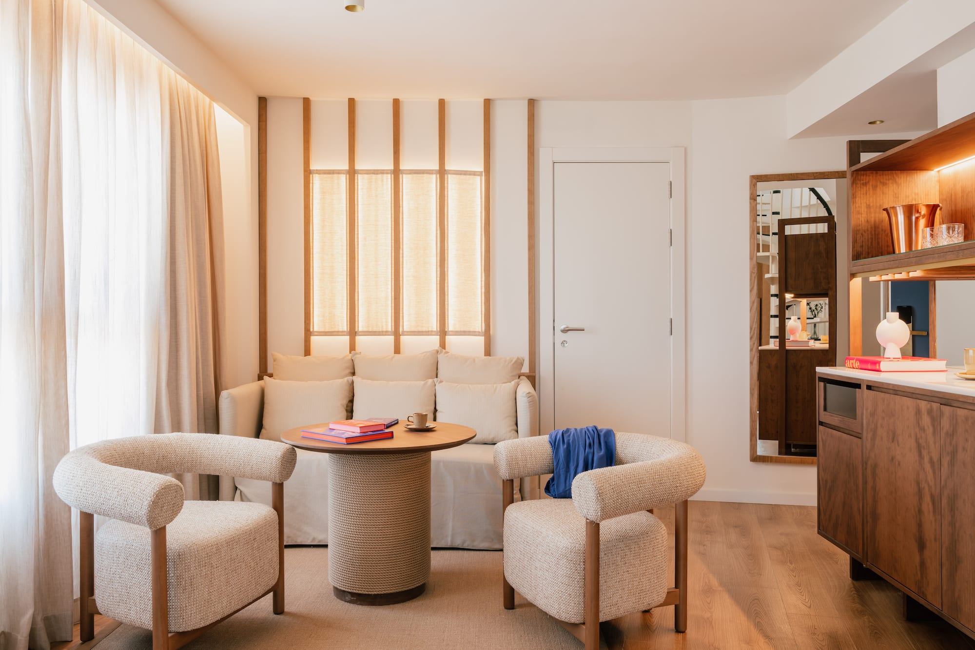 a room with a couch and chairs