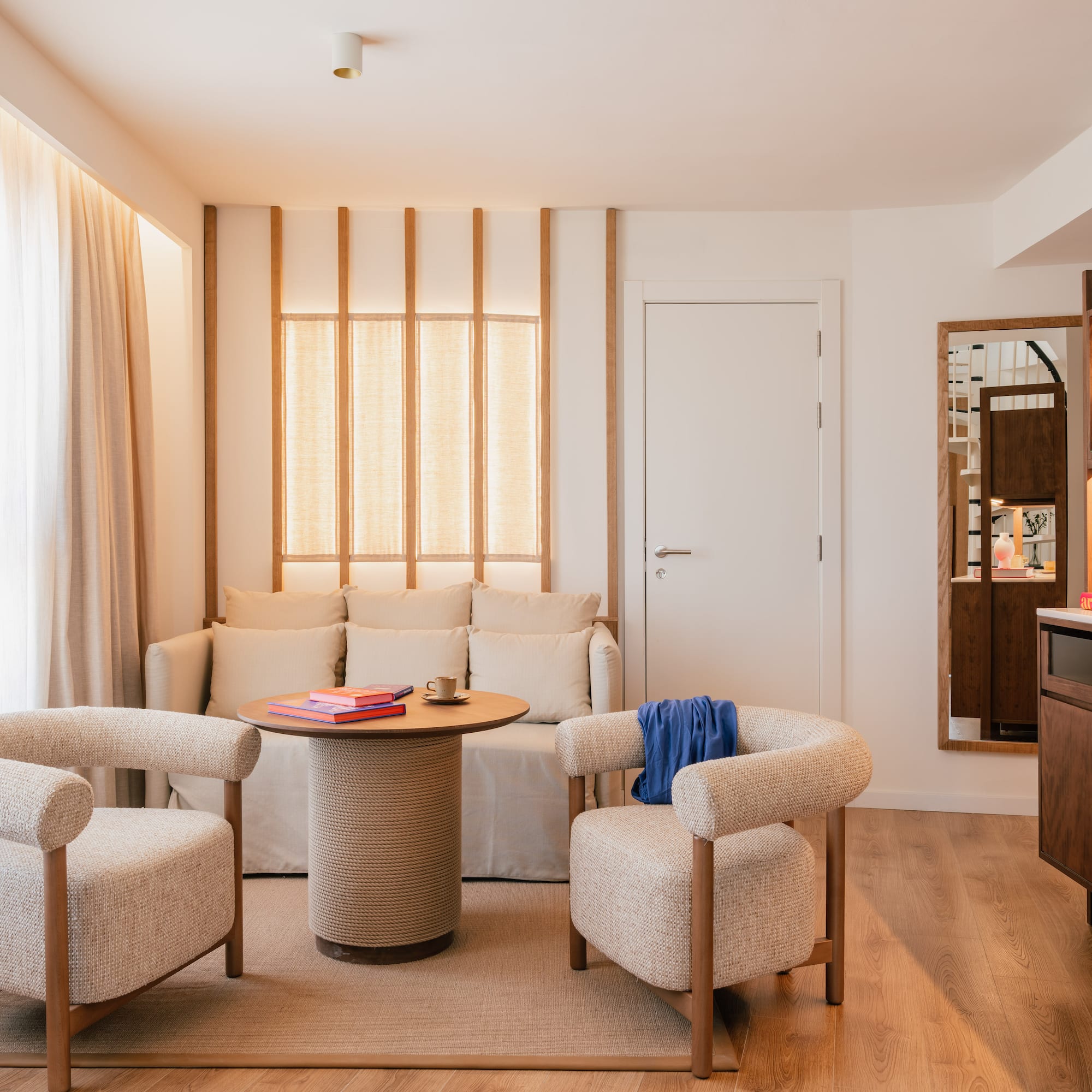 a room with a couch and chairs