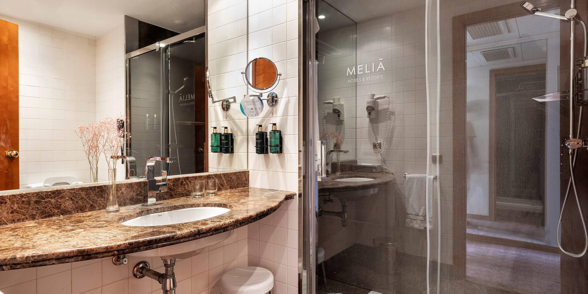 a bathroom with a glass shower and sink