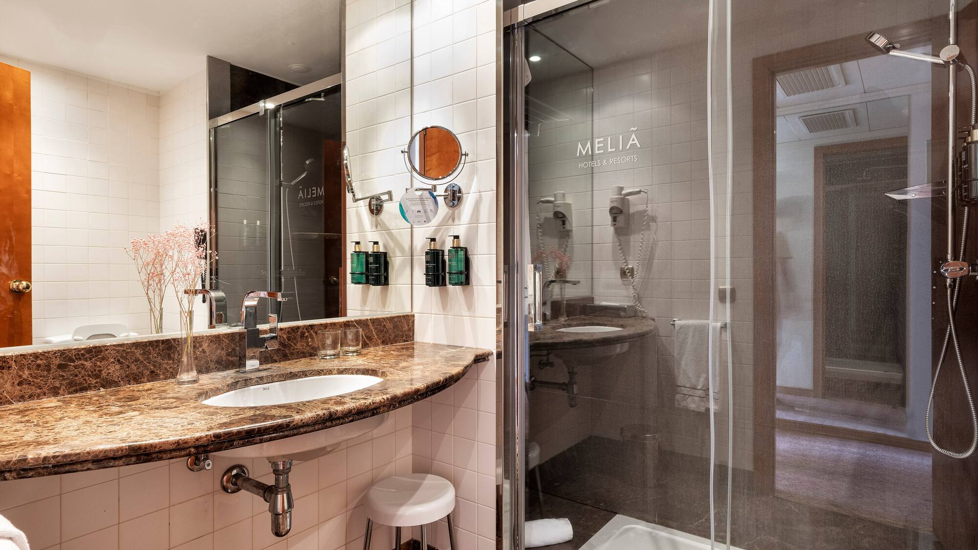a bathroom with a glass shower and sink