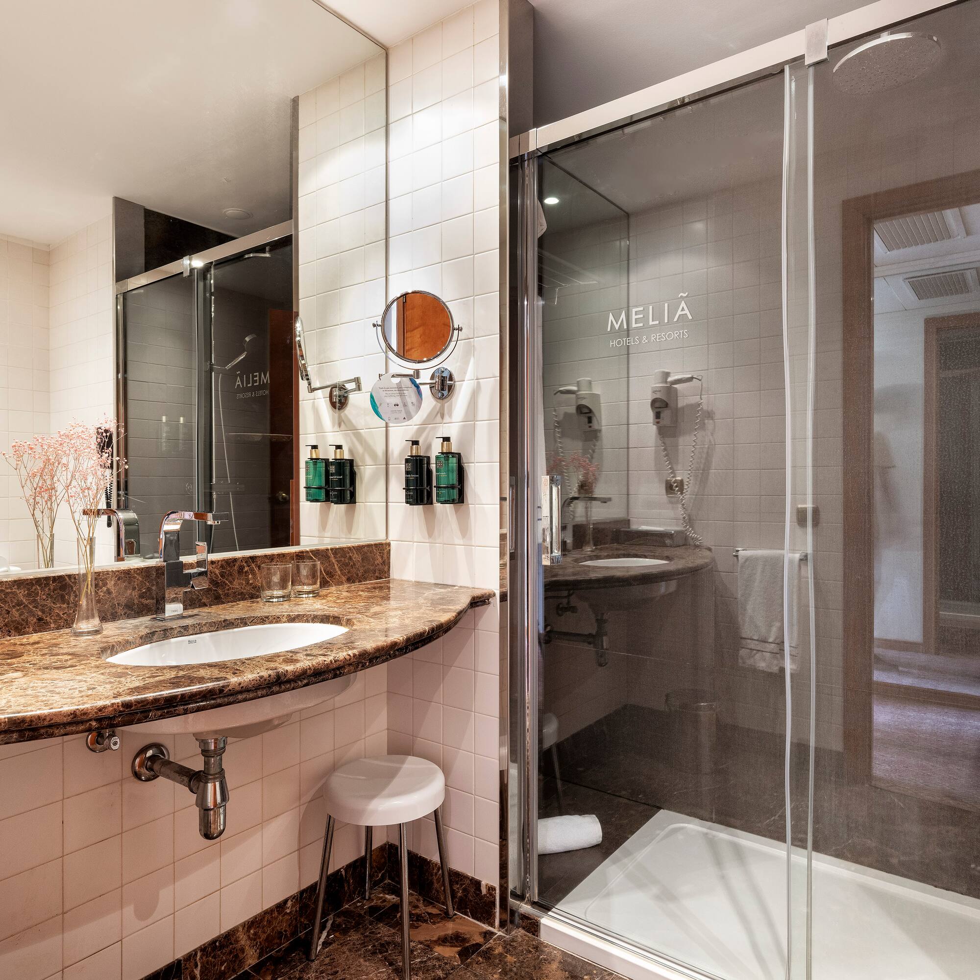 a bathroom with a glass shower and sink