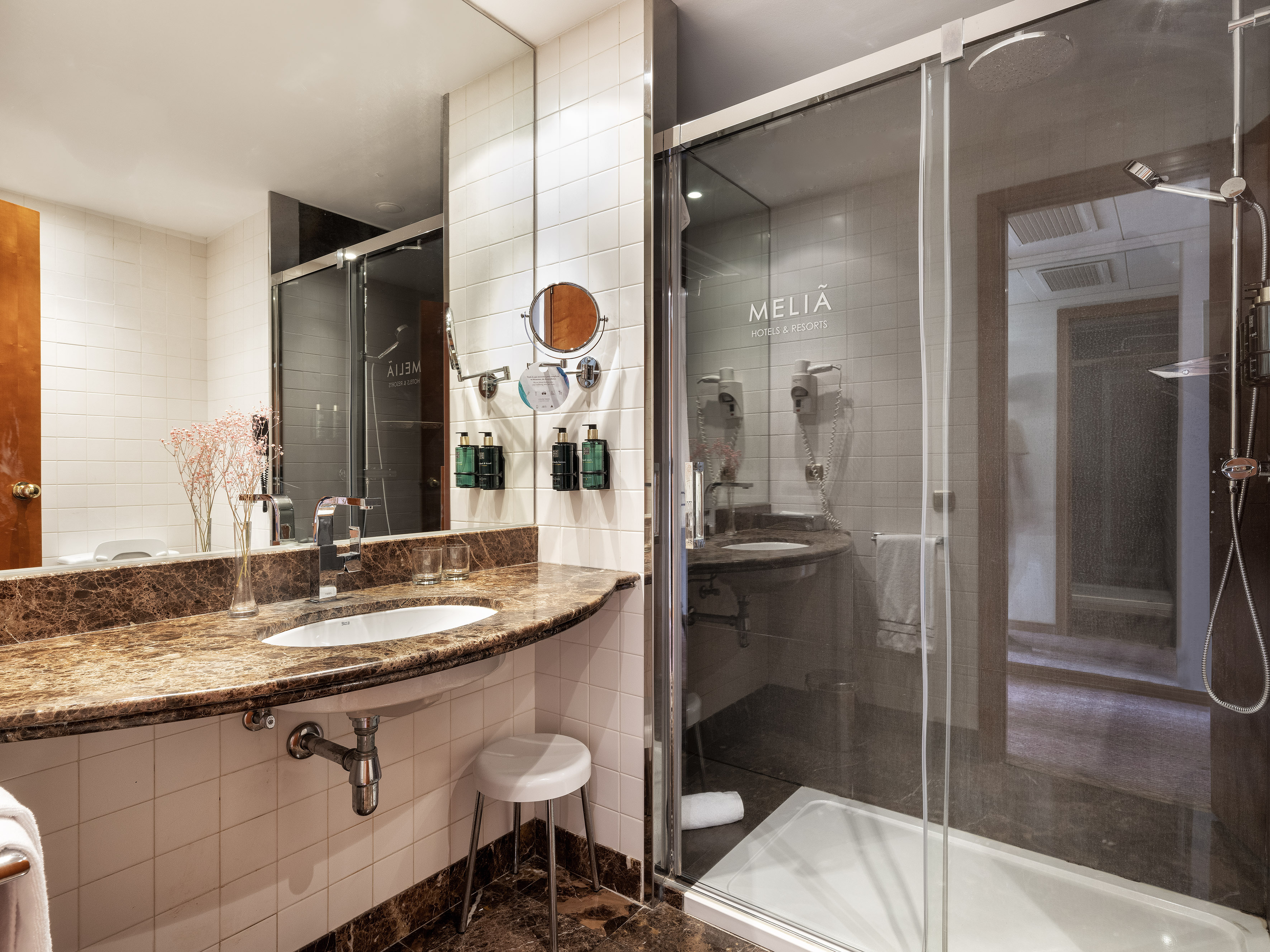 a bathroom with a glass shower and sink