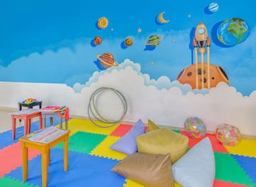 a room with a mural of planets and a rocket
