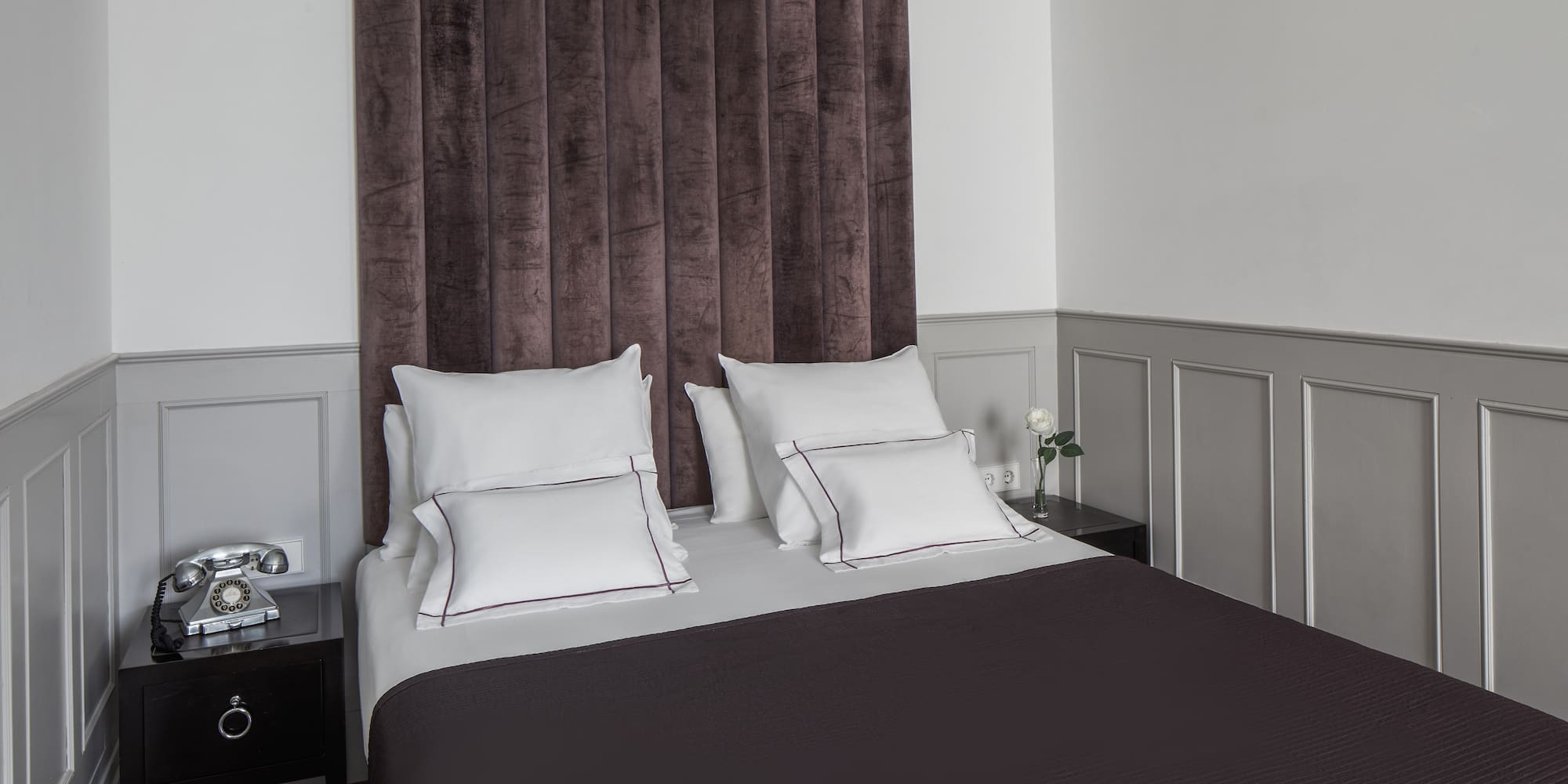 a bed with pillows and a curtain