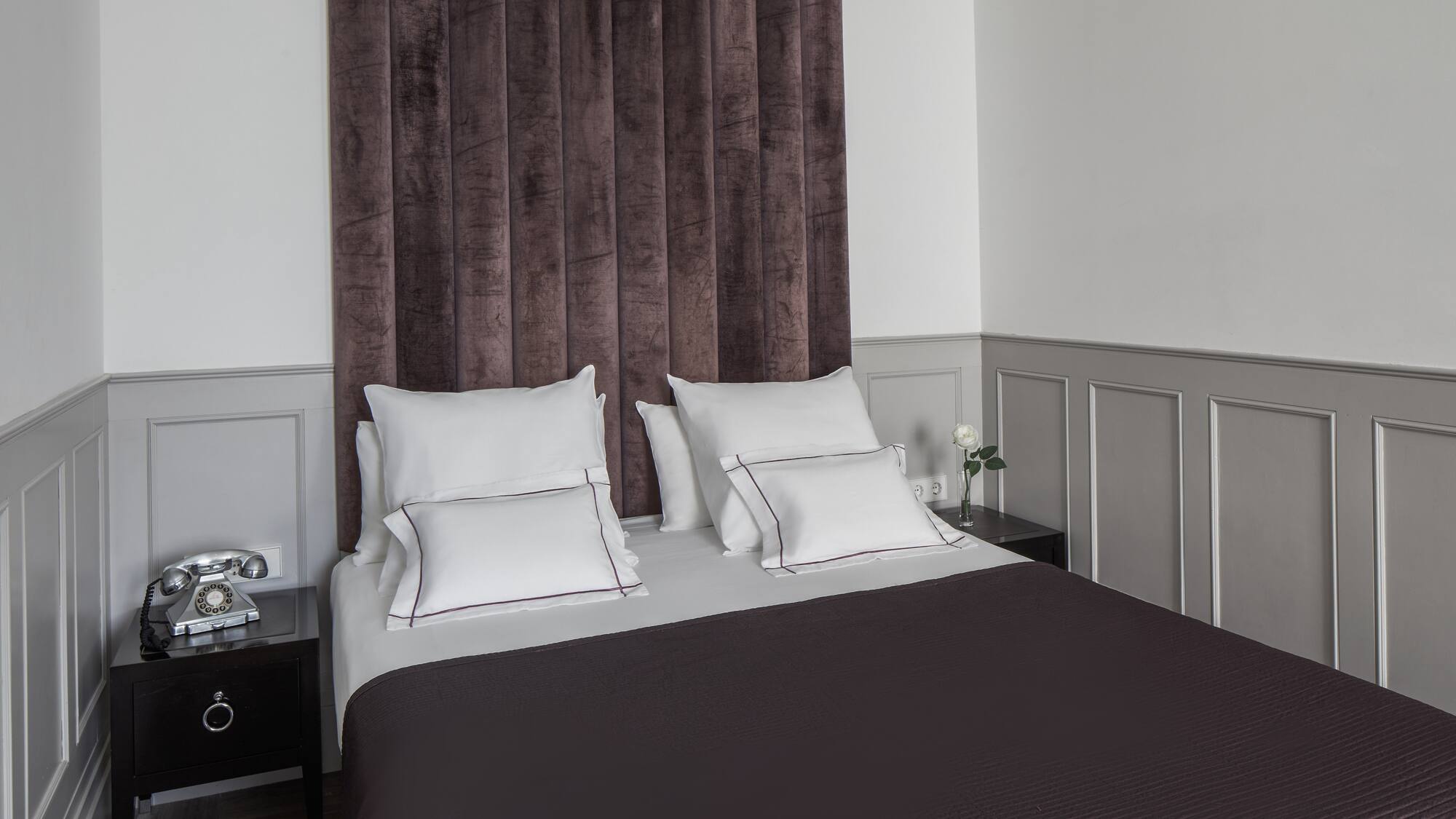 a bed with pillows and a curtain