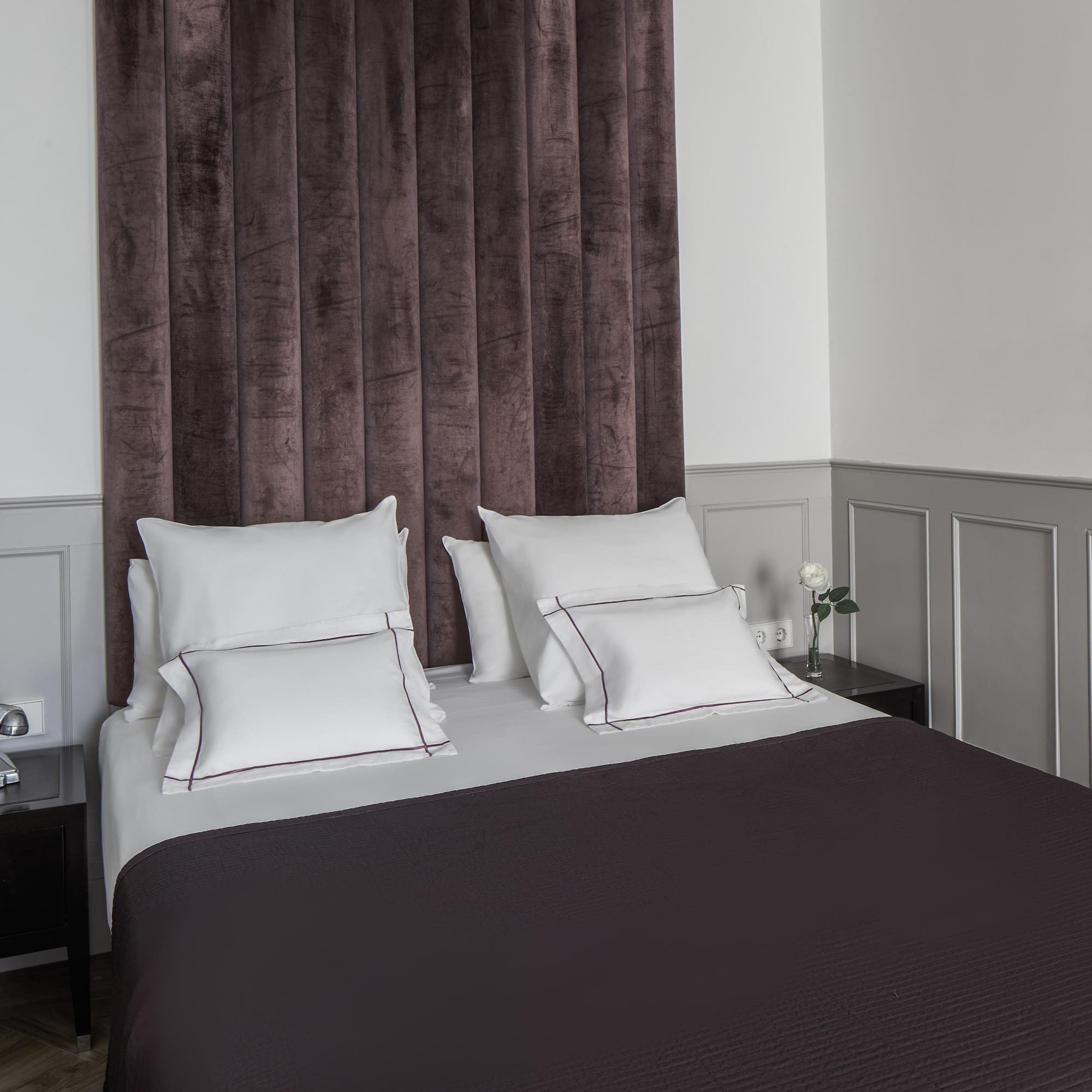 a bed with pillows and a curtain