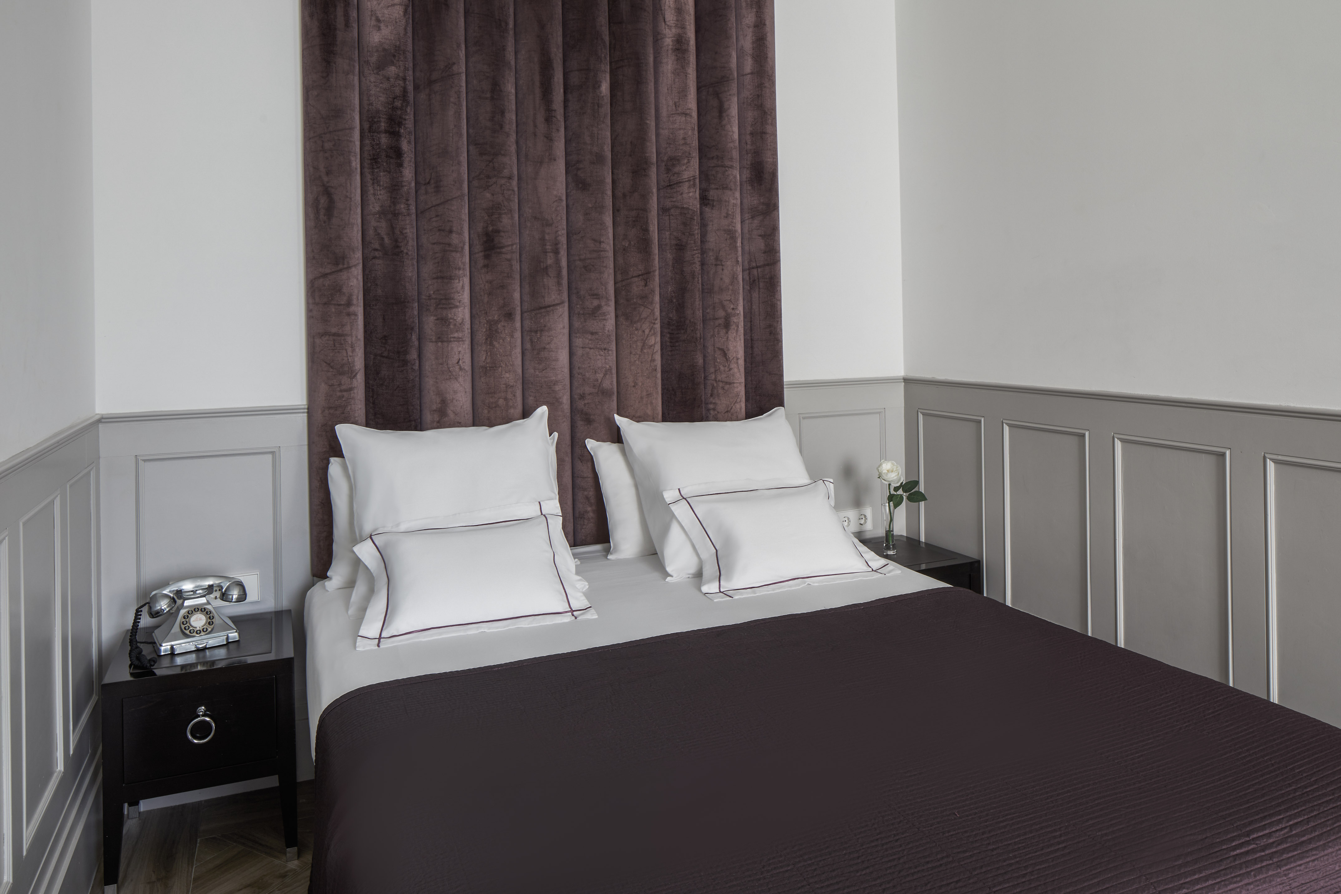 a bed with pillows and a curtain