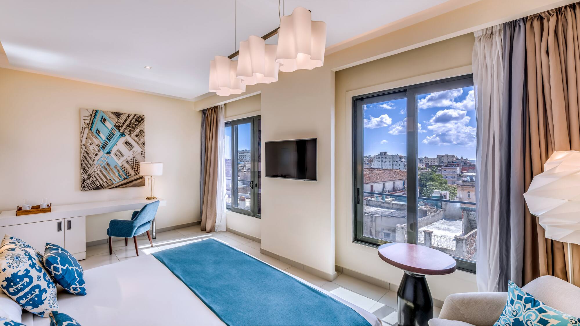 a room with a bed and a television