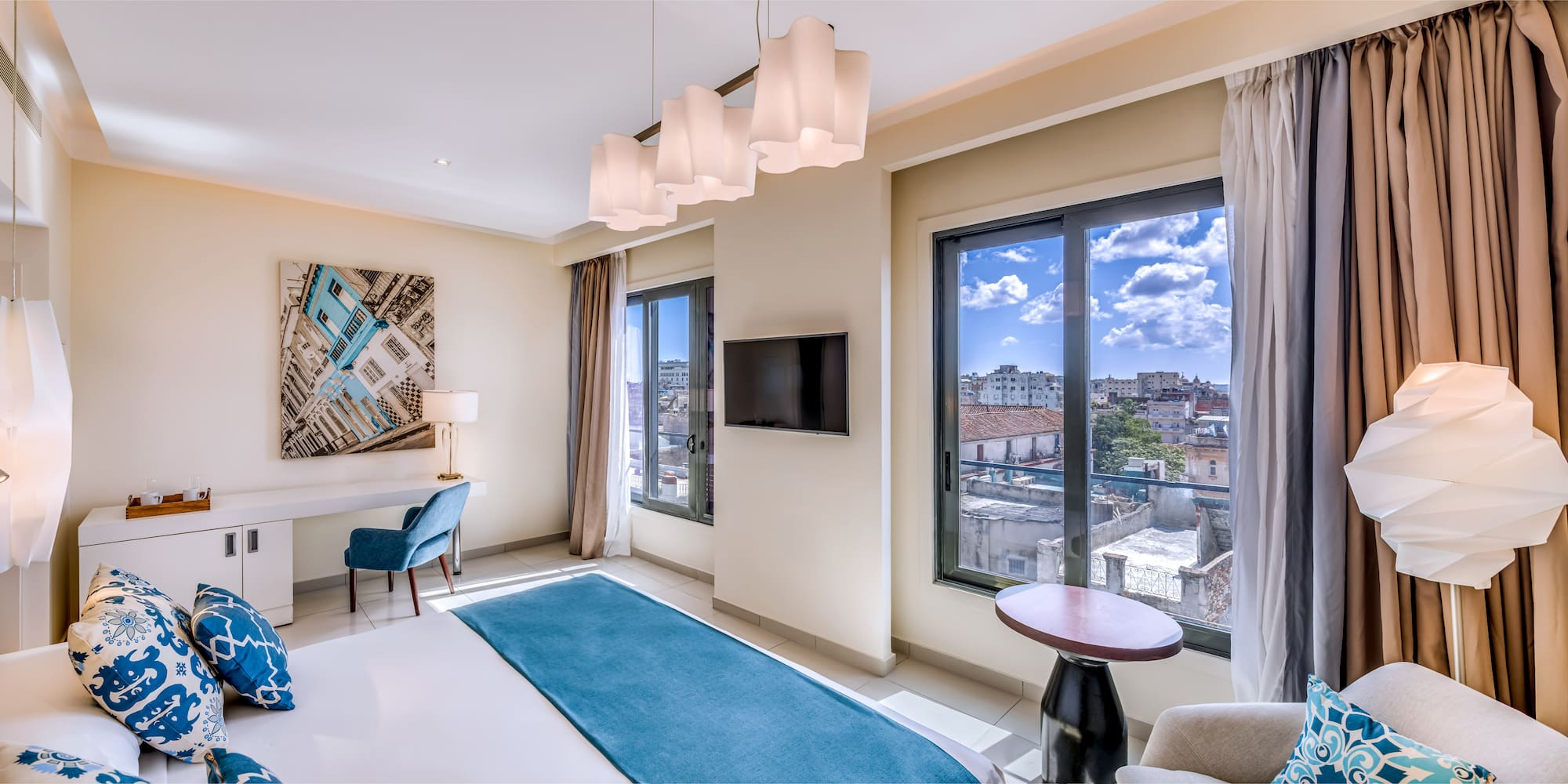 a room with a bed and a television