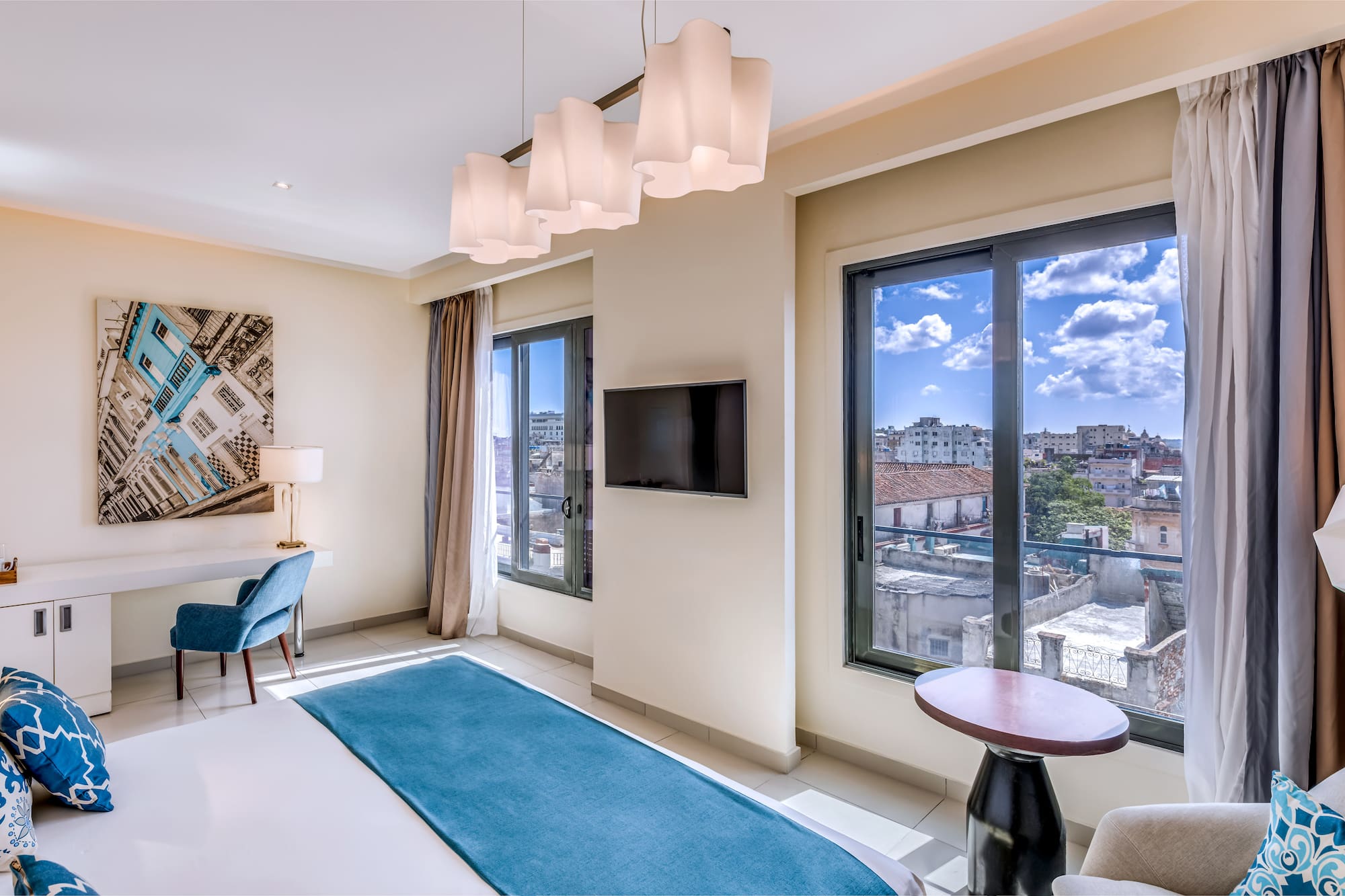 a room with a bed and a television