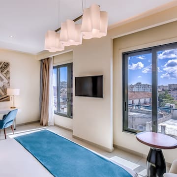 a room with a bed and a television