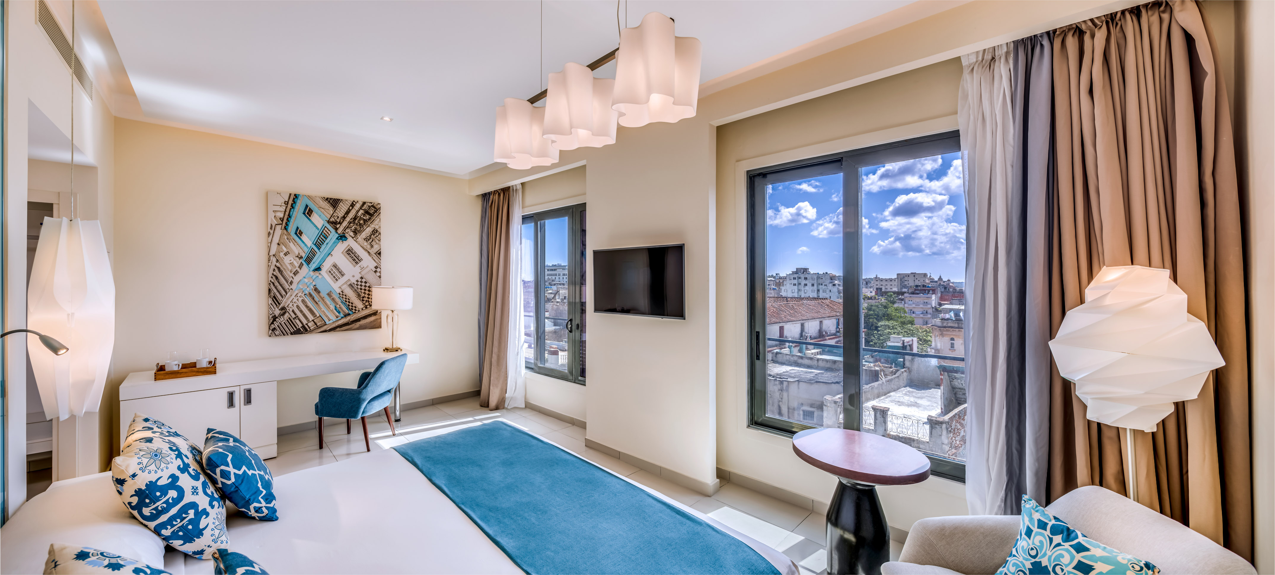 a room with a bed and a television