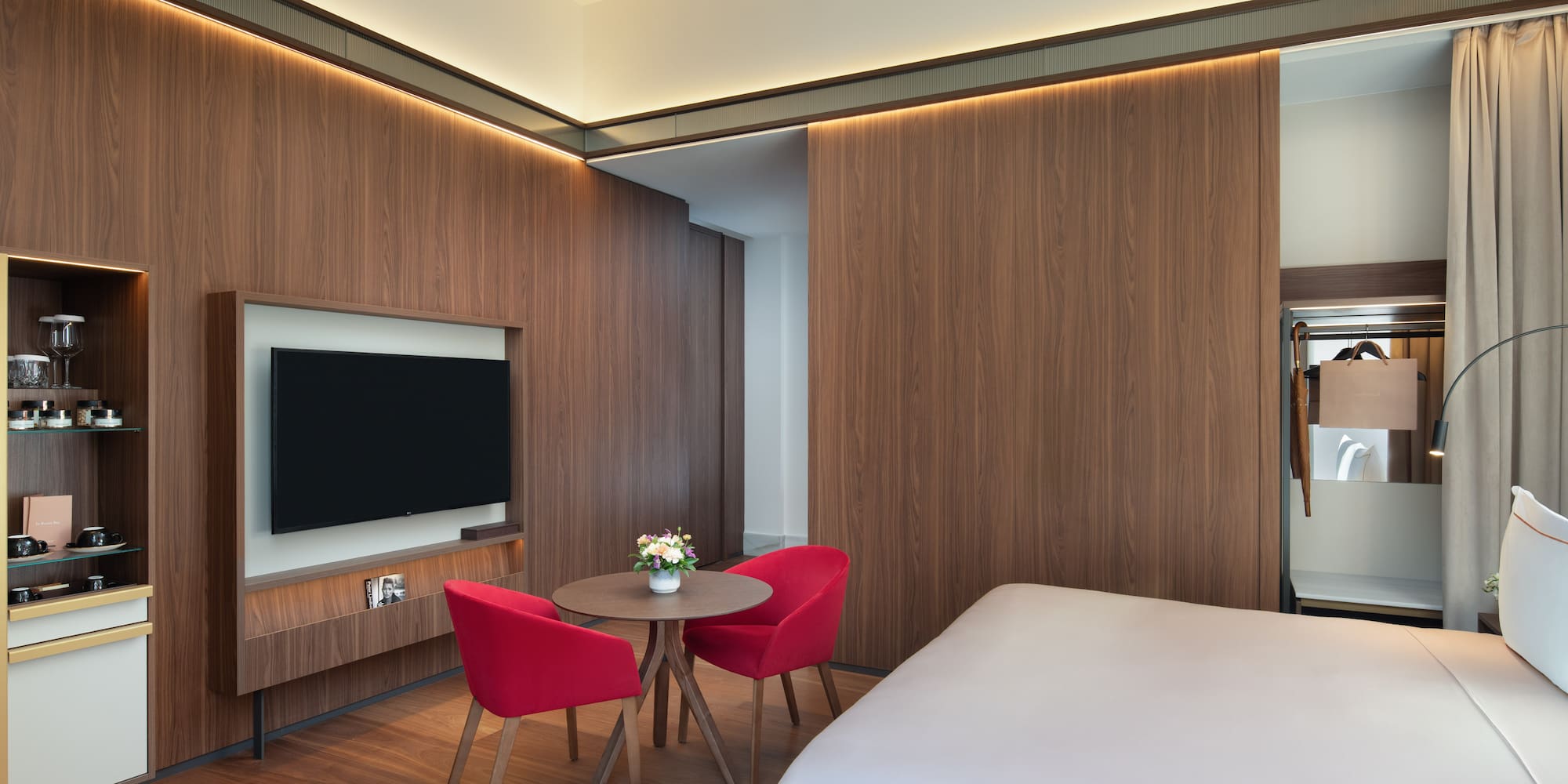 a room with a bed and a table and chairs