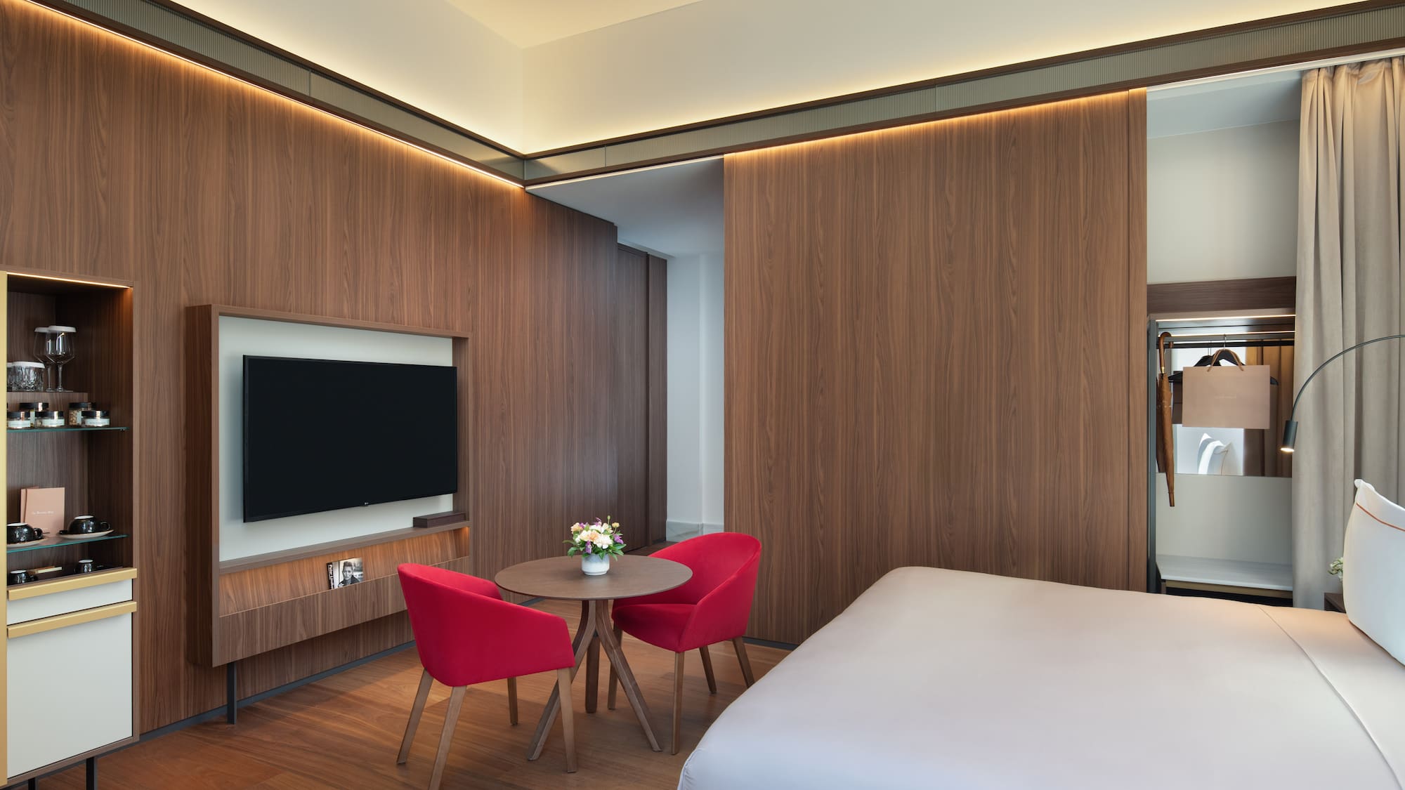 a room with a bed and a table and chairs