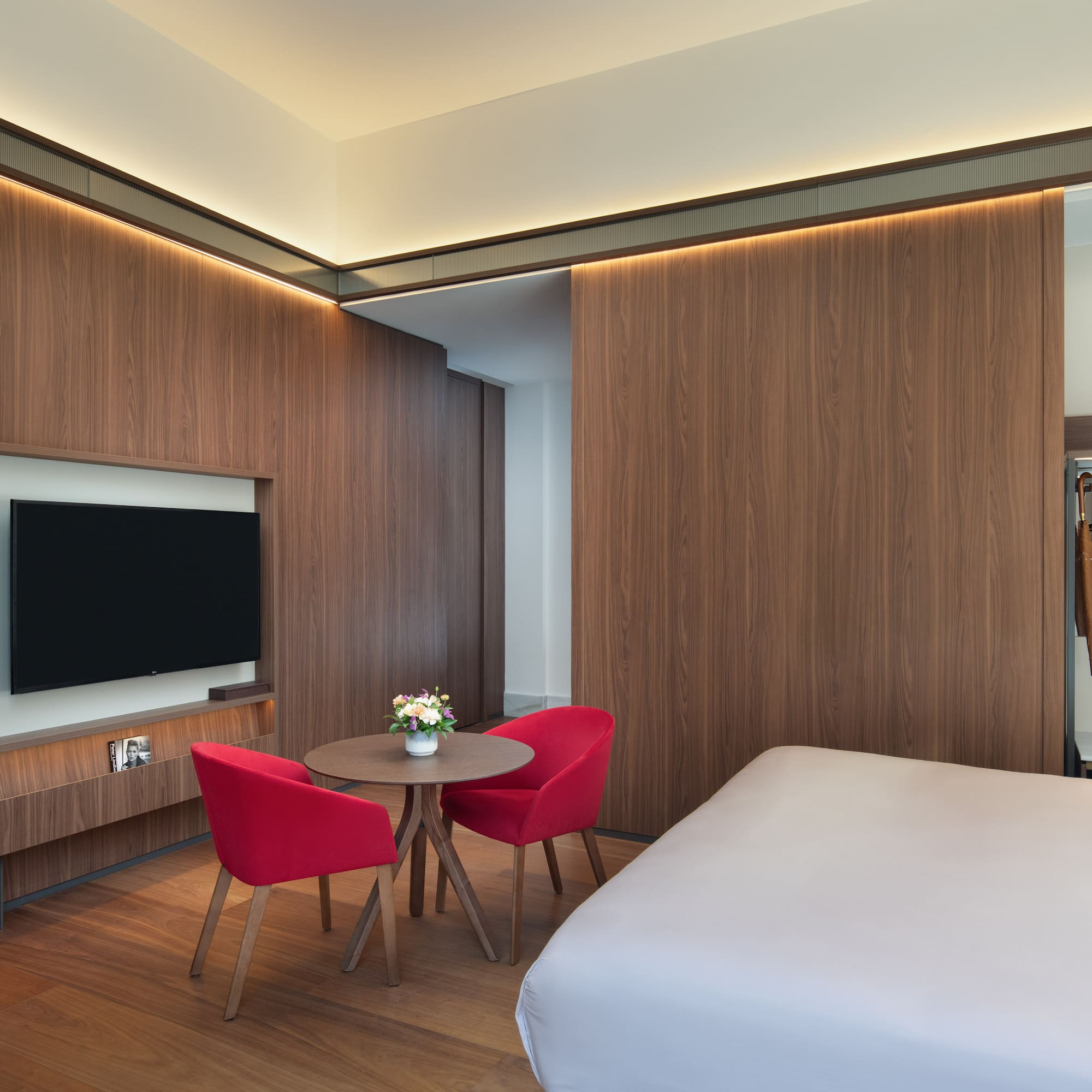 a room with a bed and a table and chairs