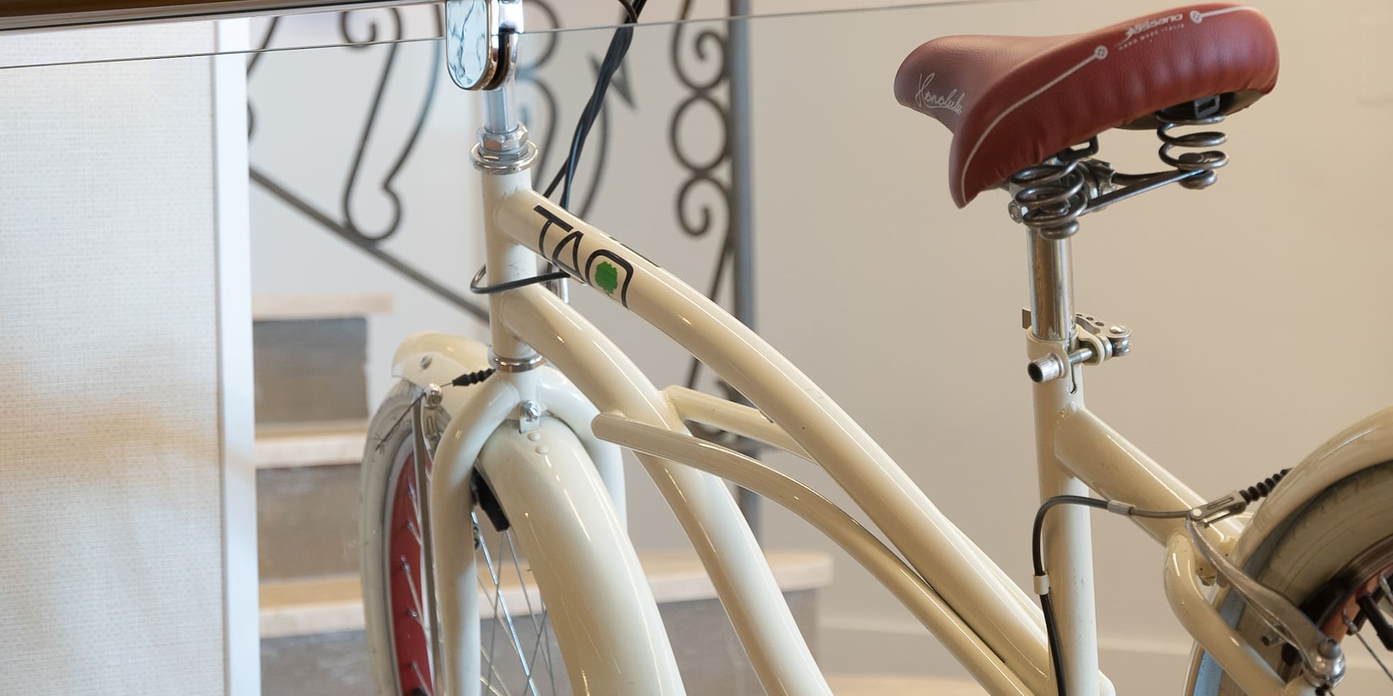 a white bicycle with red seat