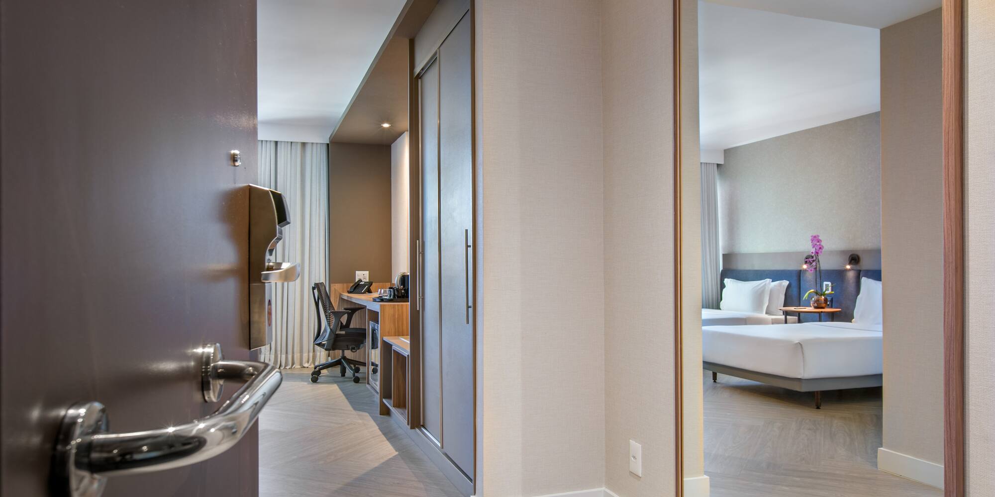 a room with a mirror and a bed