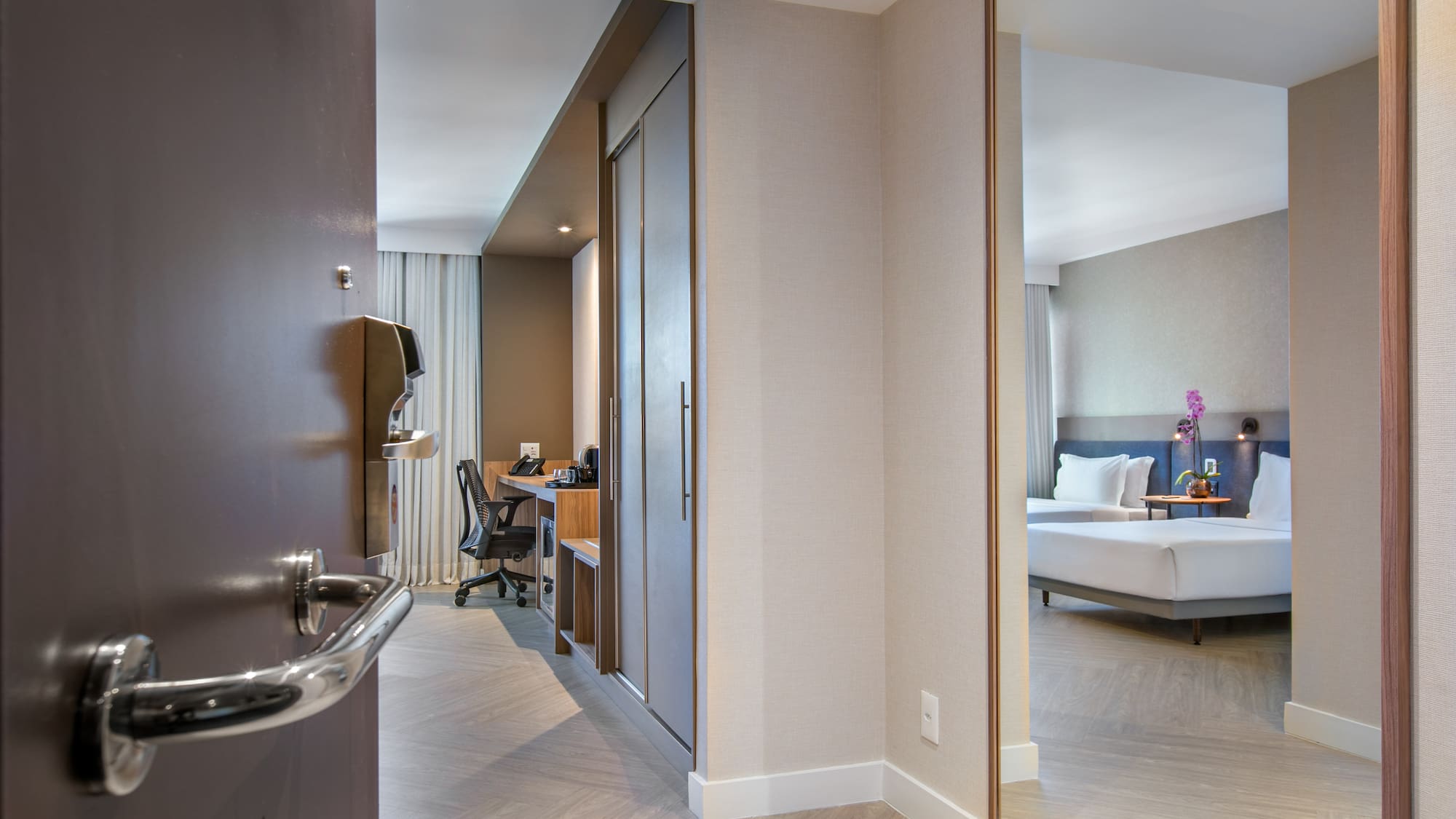 a room with a mirror and a bed