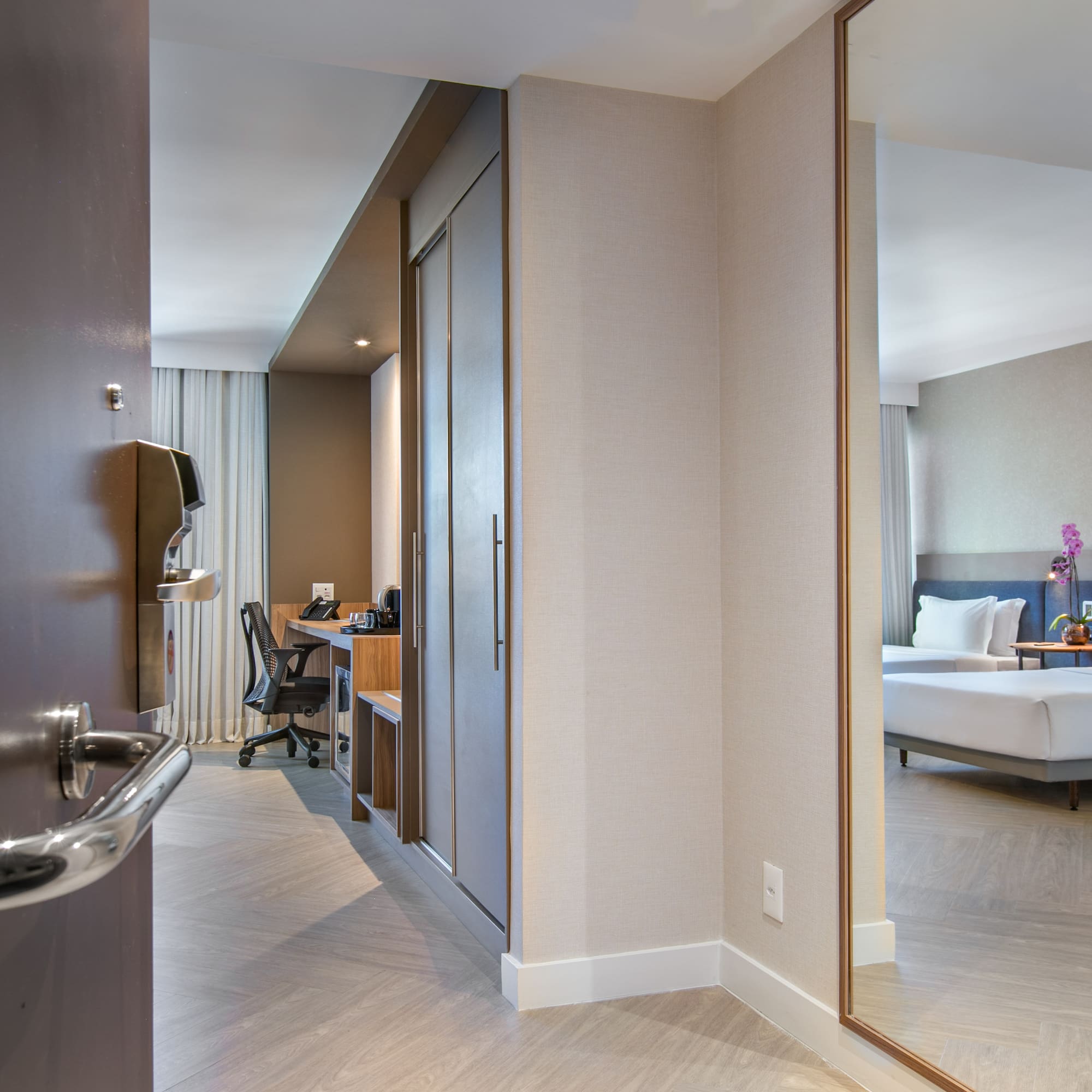 a room with a mirror and a bed