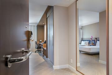 a room with a mirror and a bed